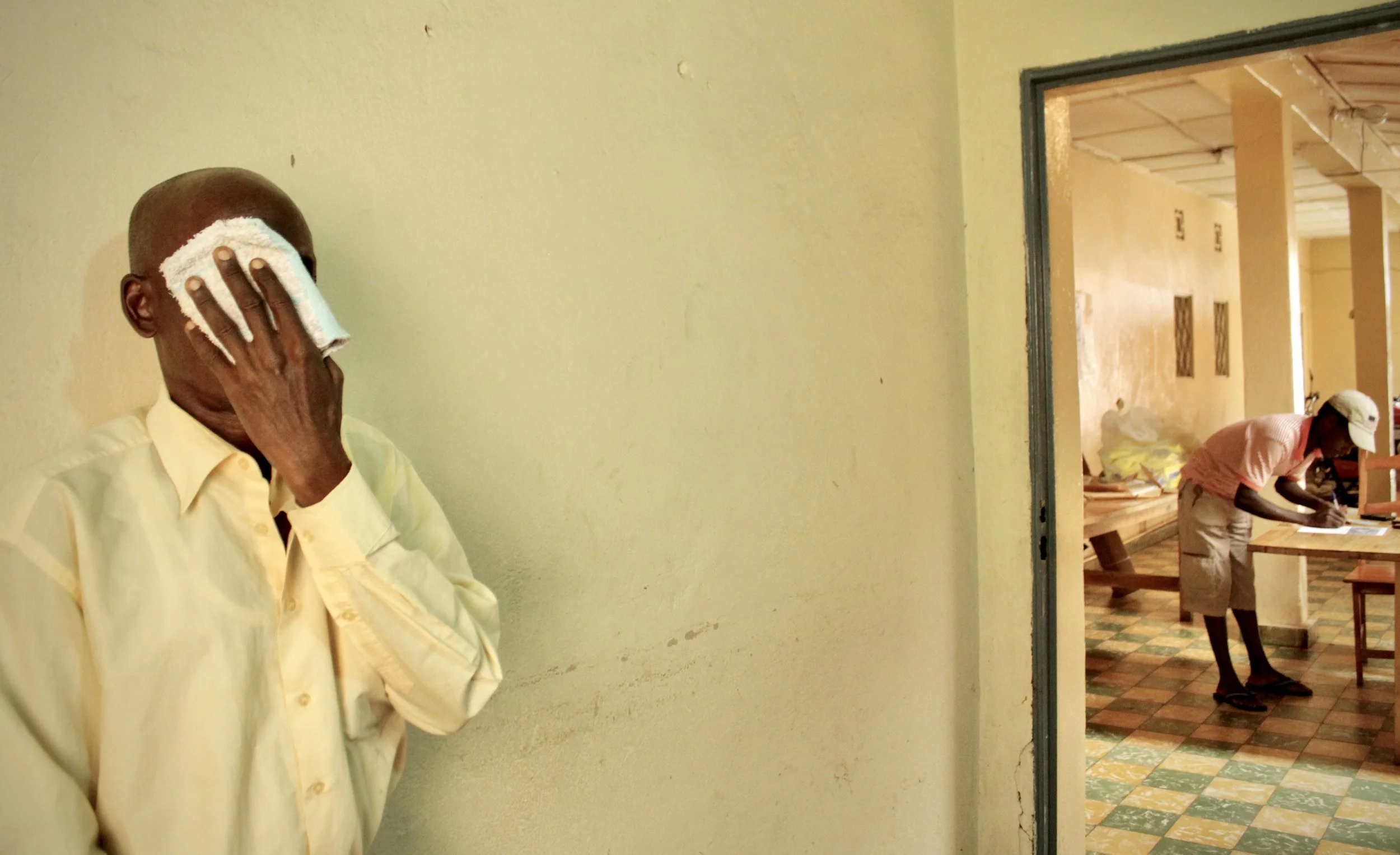 P. Sinzinkayo, who claimed members of Burundi's intelligence agency forced him to lay on car battery acid, waits outside following an interview with investigators and support workers. "I was like dead".