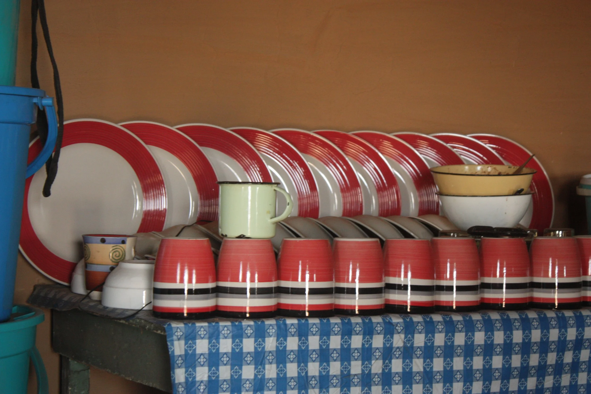 Dishes and household items inside Palesa’s home in Thaba Moorosi, Lithipeng,. The series focuses closely on ordinary domestic spaces shaped by poverty, care work and isolation.