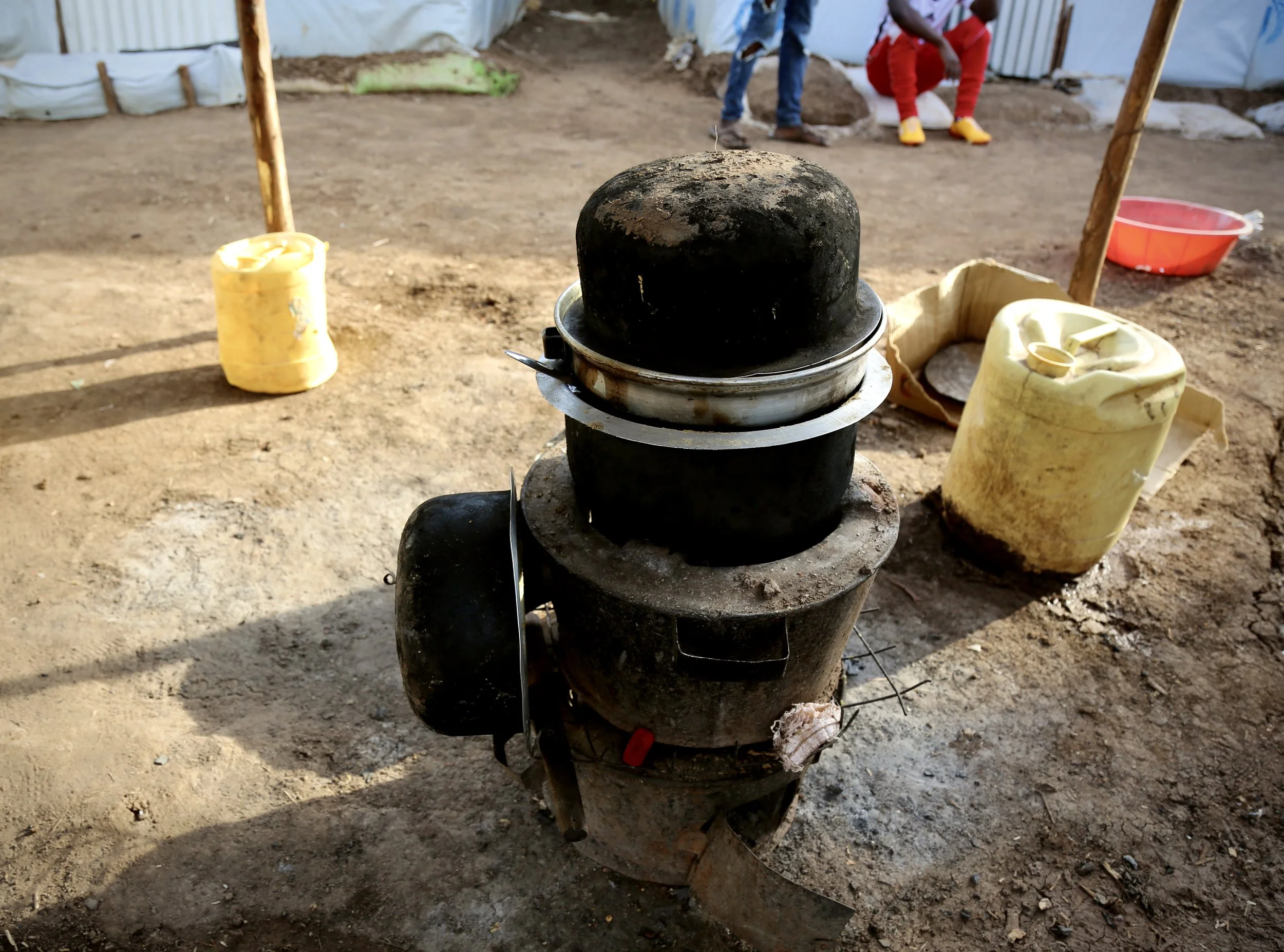 Cooking pots and water containers outside a shelter in Kakuma refugee camp, where residents described struggling with shortages of food, water and basic supplies.