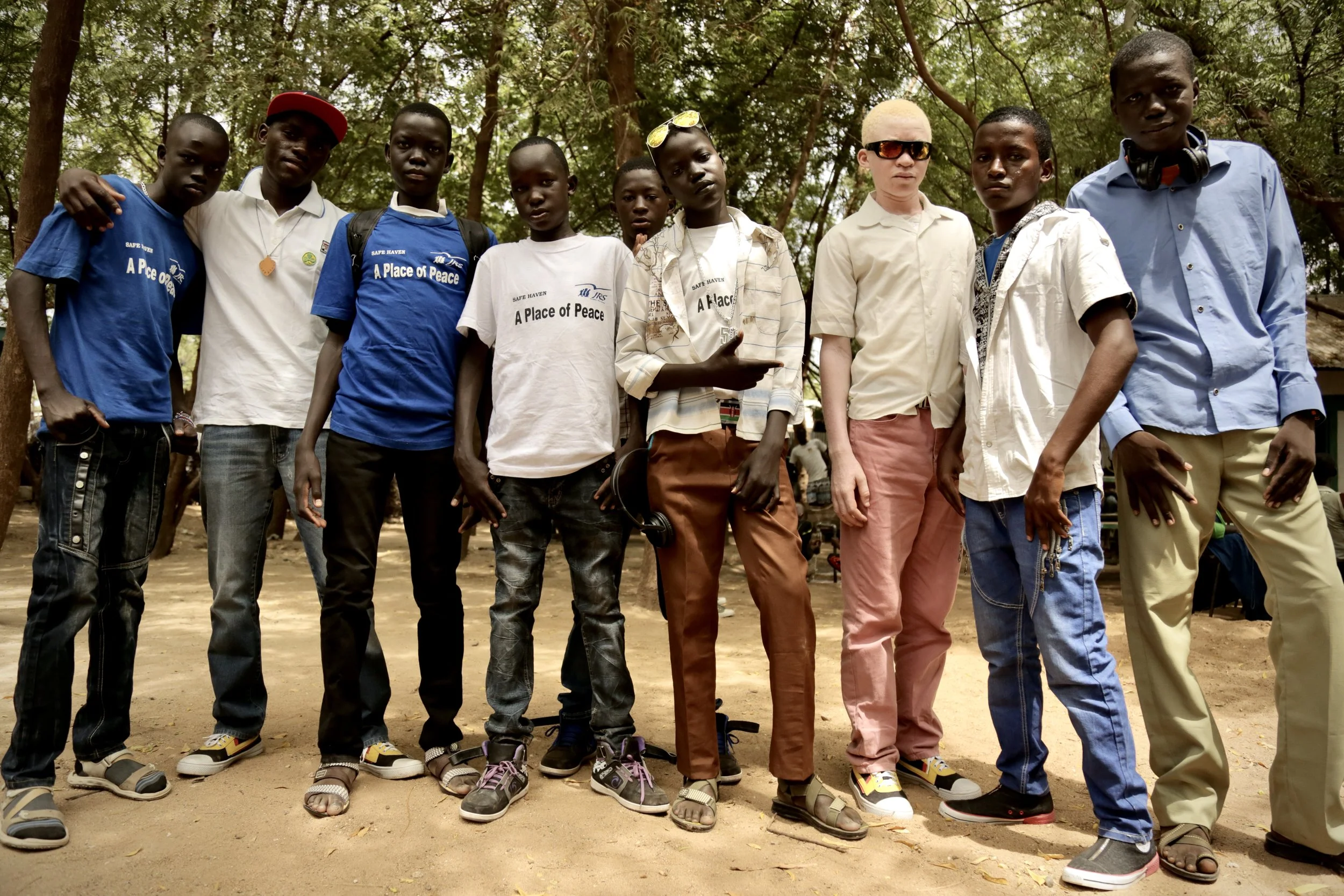 Evariste stands among other teenagers in Kakuma. Despite isolation and fear, he sought friendship and belonging like any other adolescent.