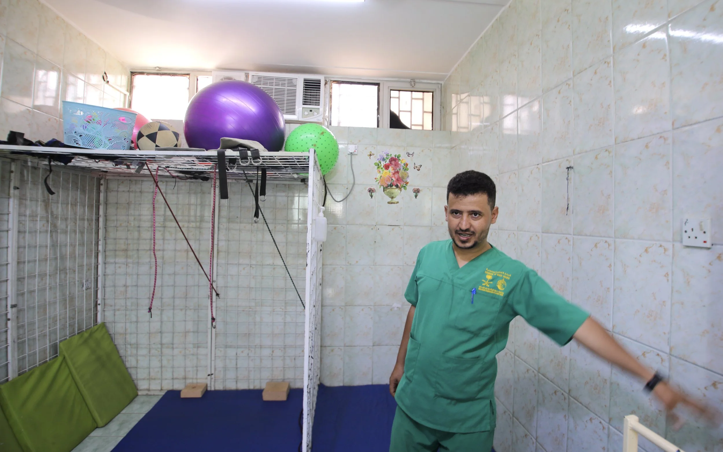 A physiotherapist demonstrates the balance and movement exercises used with patients newly fitted with prosthetic limbs at the rehabilitation centre in Aden.