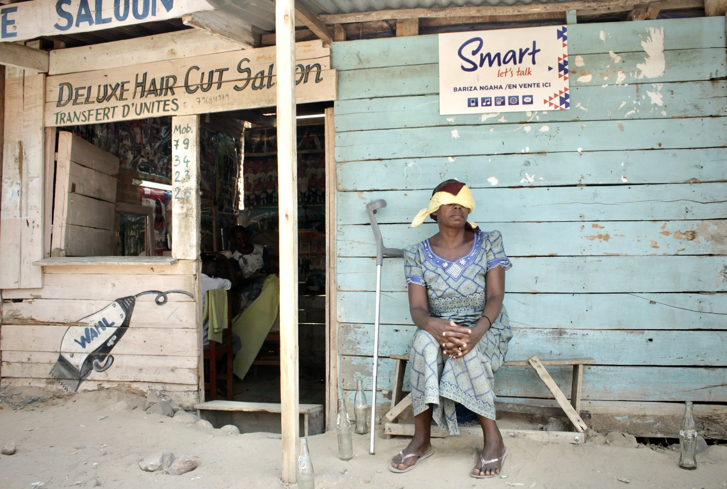 I.N., a 51-year-old mother of five from the Mutakura district of Bujumbura, sits outside a safe location in July 2015. She said police shot her during a search of her home after accusing residents of hiding weapons and opposition fighters. "I thought