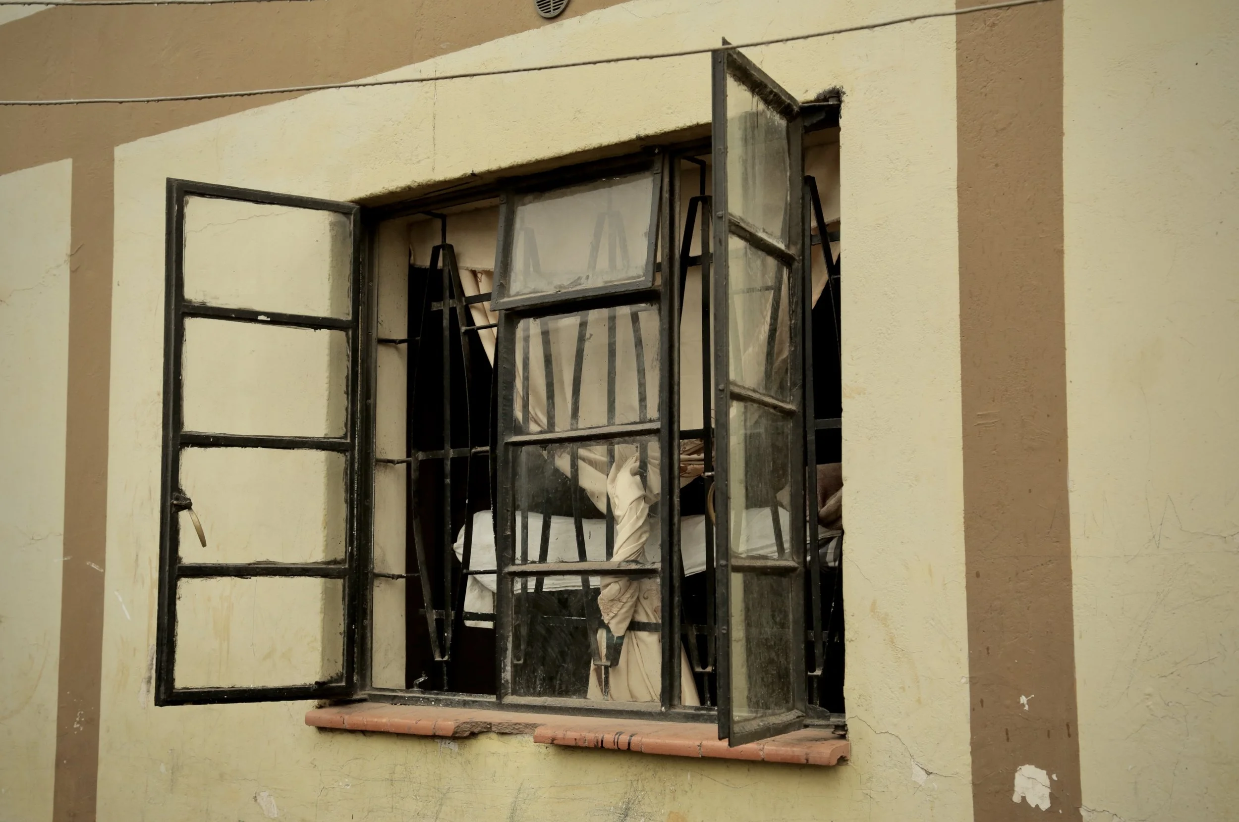 An apartment window in Nairobi's Eastleigh district. Four Somali sisters who fled Kakuma refugee camp were living nearby after leaving the camp amid growing fears for their safety. Nairobi, Kenya, June 2016.