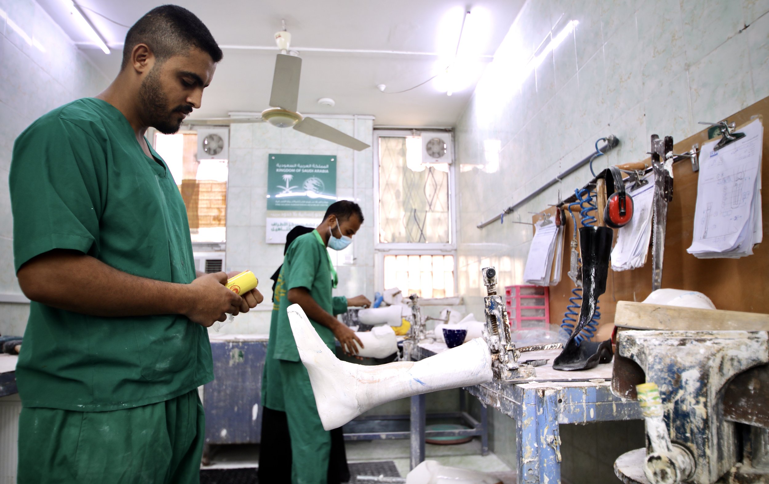 Technicians fabricate prosthetic limbs inside the rehabilitation workshop in Aden. The centre produces around 500 artificial limbs each year and carries out maintenance on another 400.
