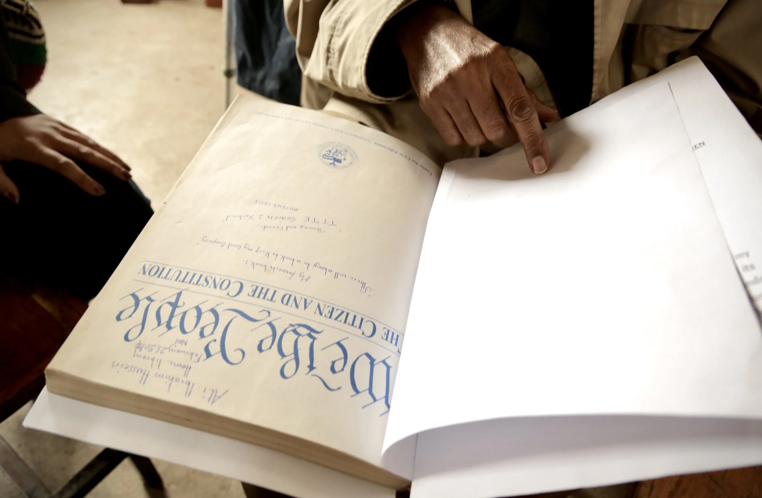 Legal documents are reviewed during a meeting with refugee advisers in Nairobi. For many Somali refugees living outside Kenya's camps, access to documentation and legal assistance remained critical to avoiding detention and possible repatriation. Nai
