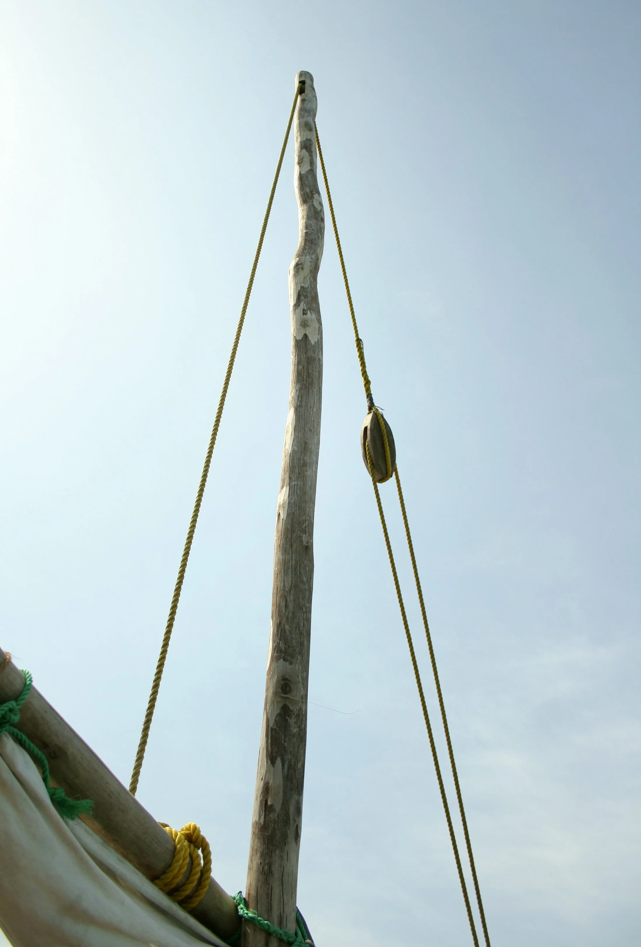Hand-carved timber, hand-spliced rope, and a wooden pulley - construction details of a dhow built using techniques passed down rather than manufactured.