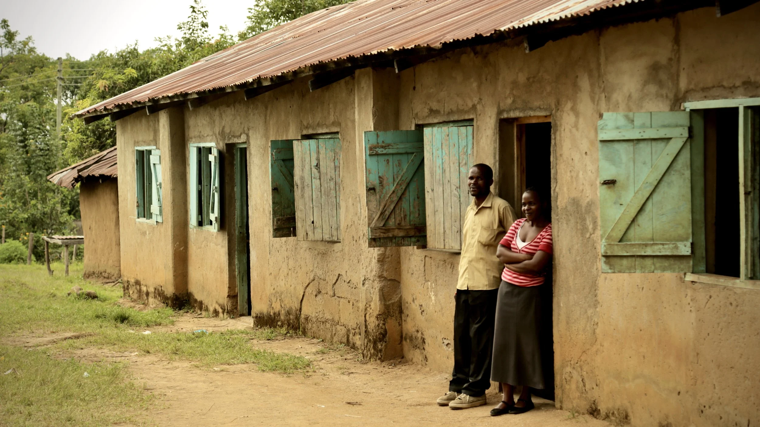 Teachers stand outside classrooms at Albertos Divine Providence School in Kakamega County. School staff say reliable water supplies are essential for preparing meals, cleaning facilities and supporting pupils throughout the school day.