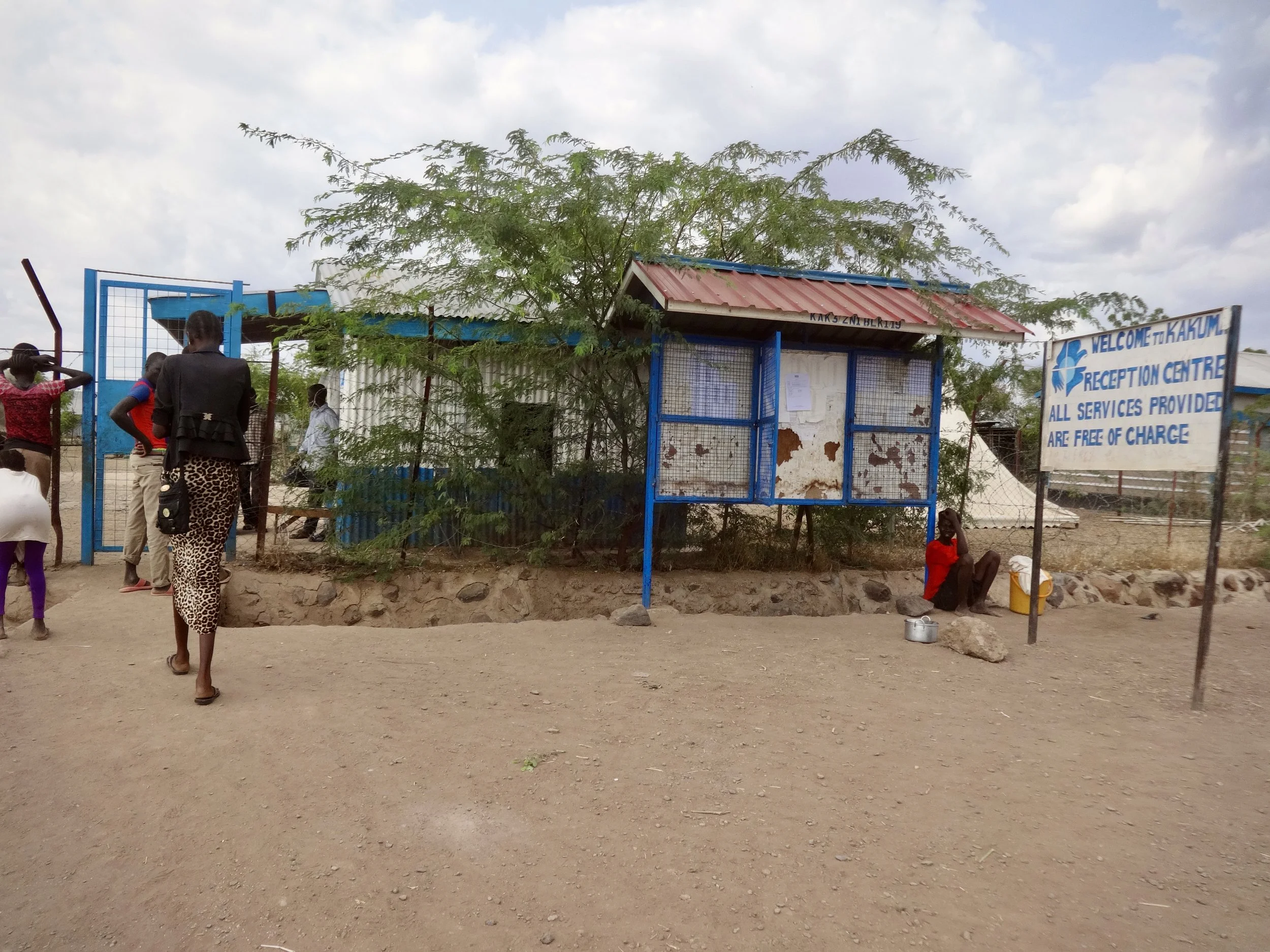 Randa walks through the gates of the Kakuma reception centre in Turkana County, Kenya, after completing registration and initial processing as an asylum seeker. Newly arrived refugees receive basic services at the centre before being allocated within