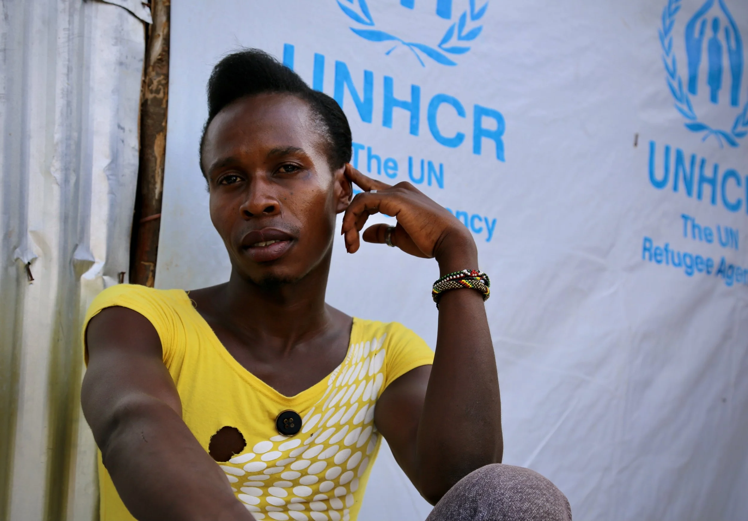 Charles Itwara, a transgender refugee from Uganda, sits outside a shelter in Kakuma refugee camp in Kenya. She said local people threw stones at her across the flimsy thorn hedge surrounding the community’s compound.