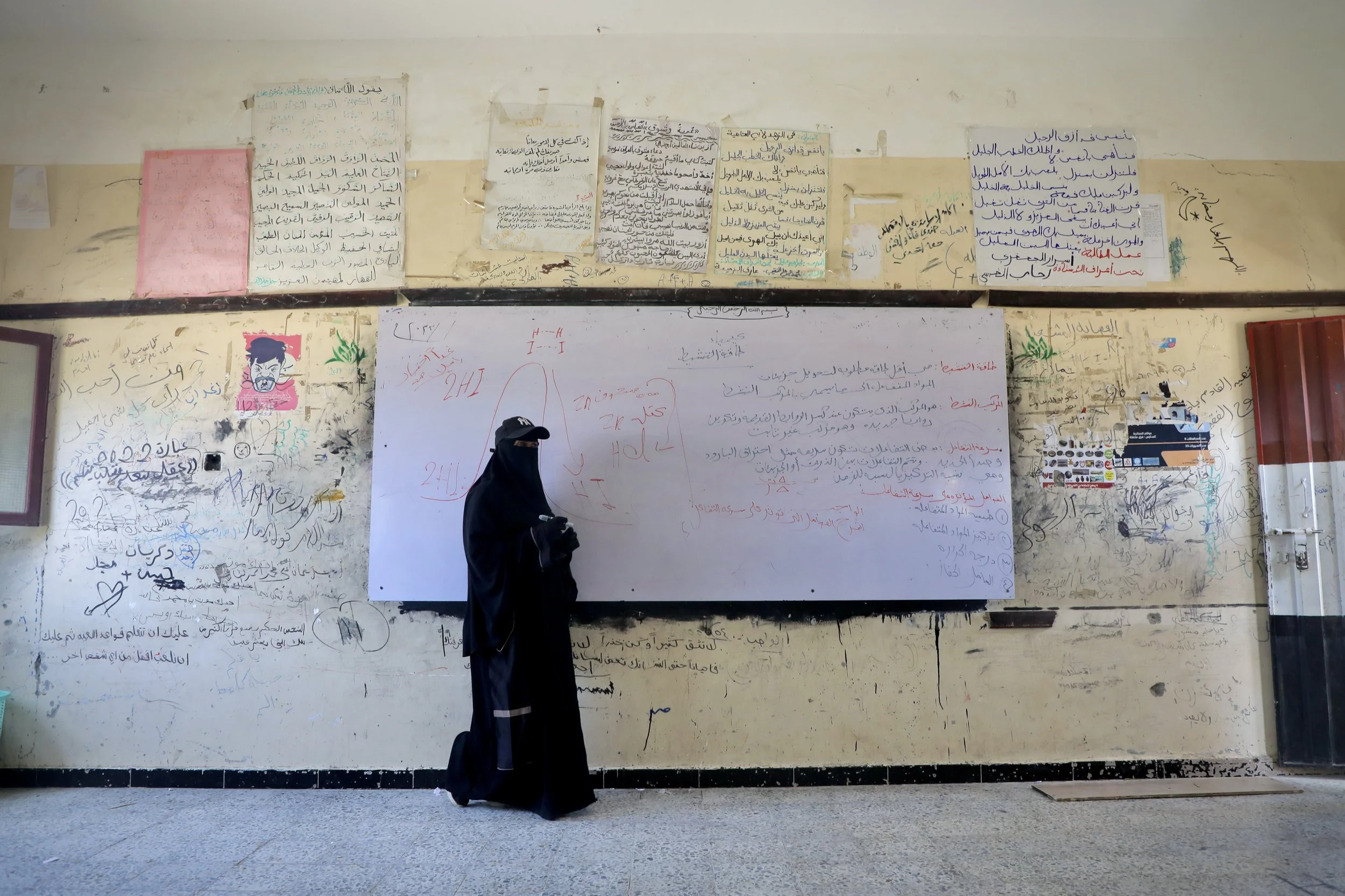 A teacher conducts a lesson inside Ibrahim Aqeel School in Taiz, where students and staff continue classes despite extensive damage to parts of the campus.