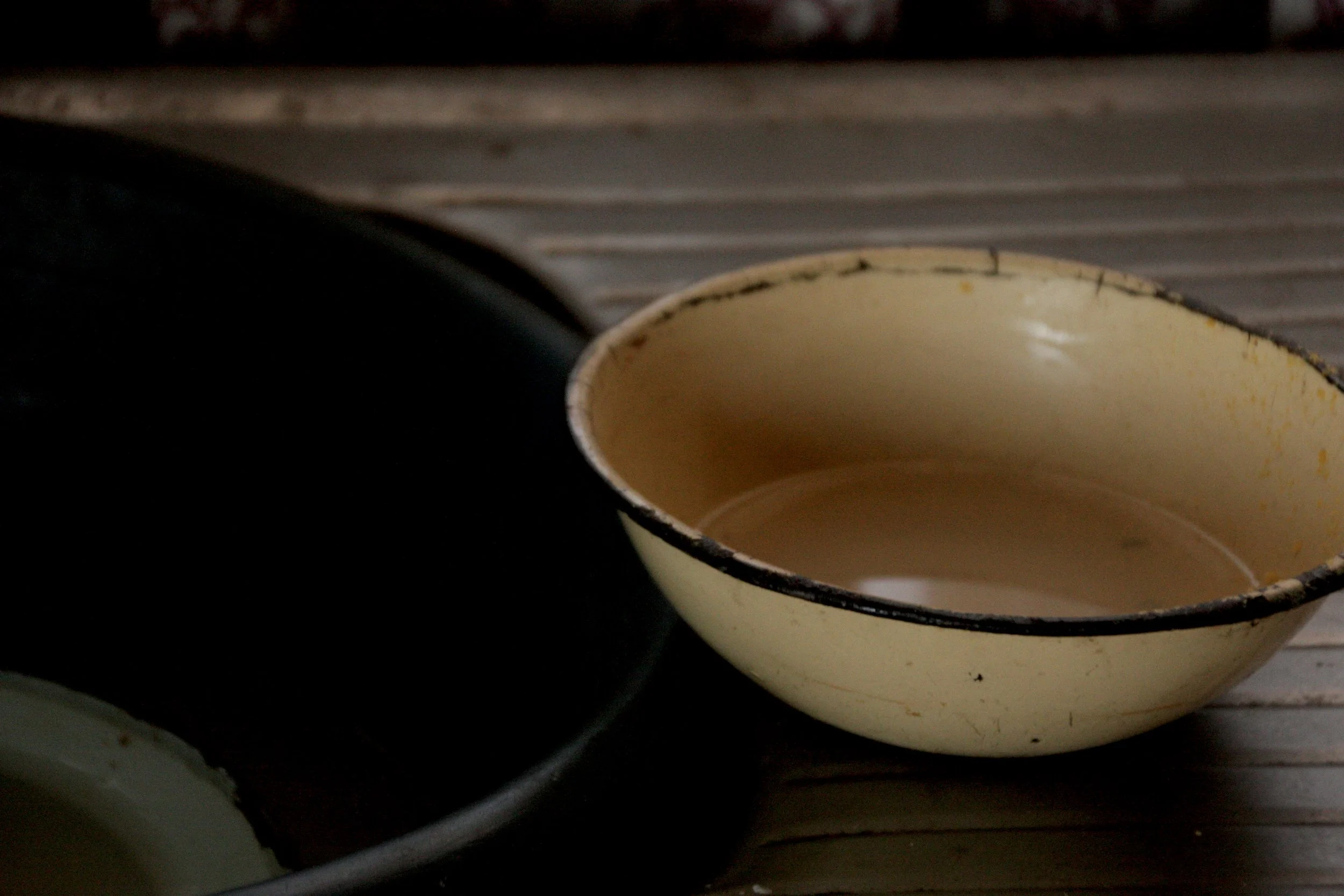 A basin sits in the kitchen of Michael’s home. Michael had been living alone before taking in his grandchildren, and says the children now help with household chores while he struggles to provide for the family on his pension income alone.