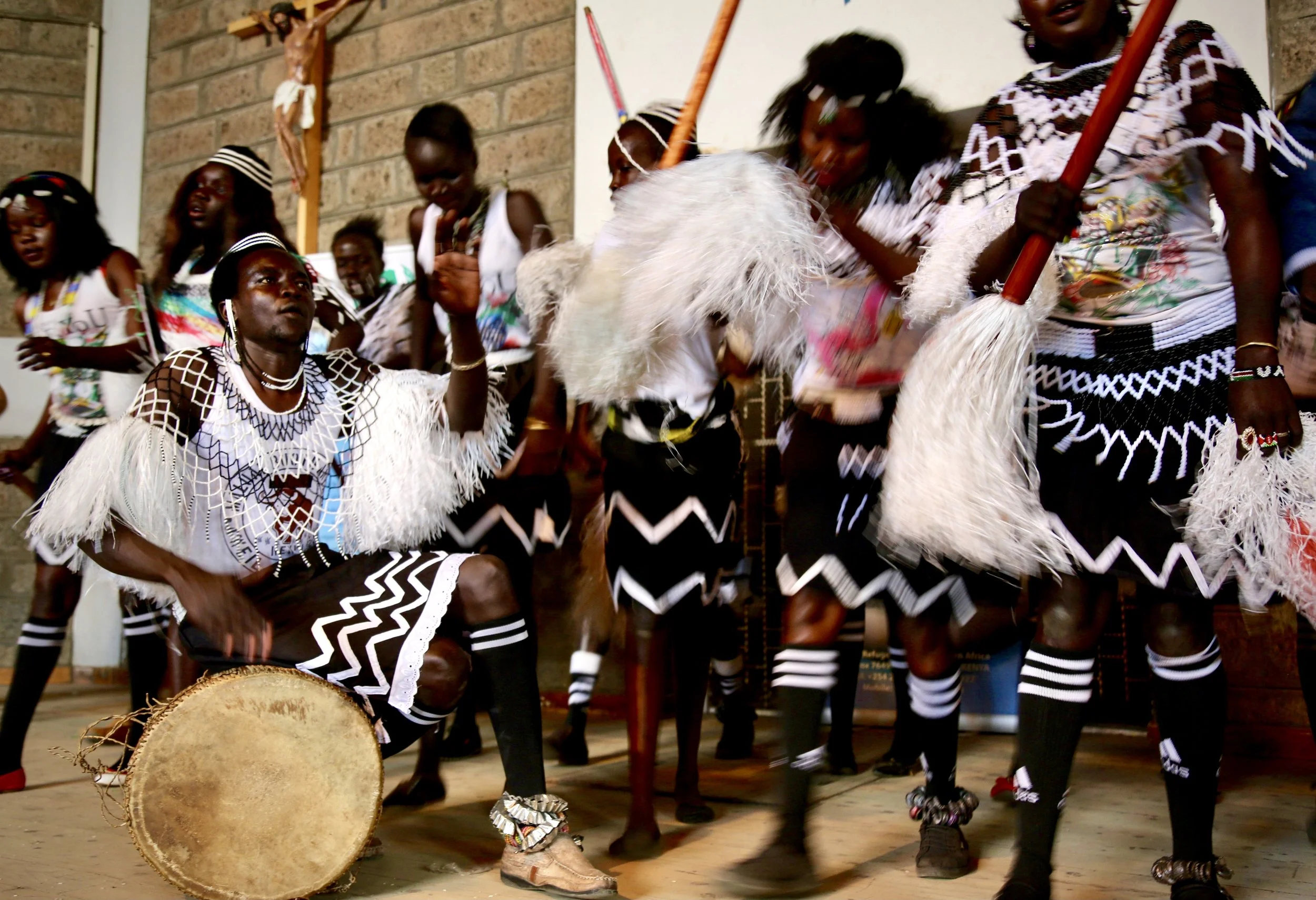 Refugee performers dance and play drums during a cultural presentation celebrating World Refugee Day in Nairobi.