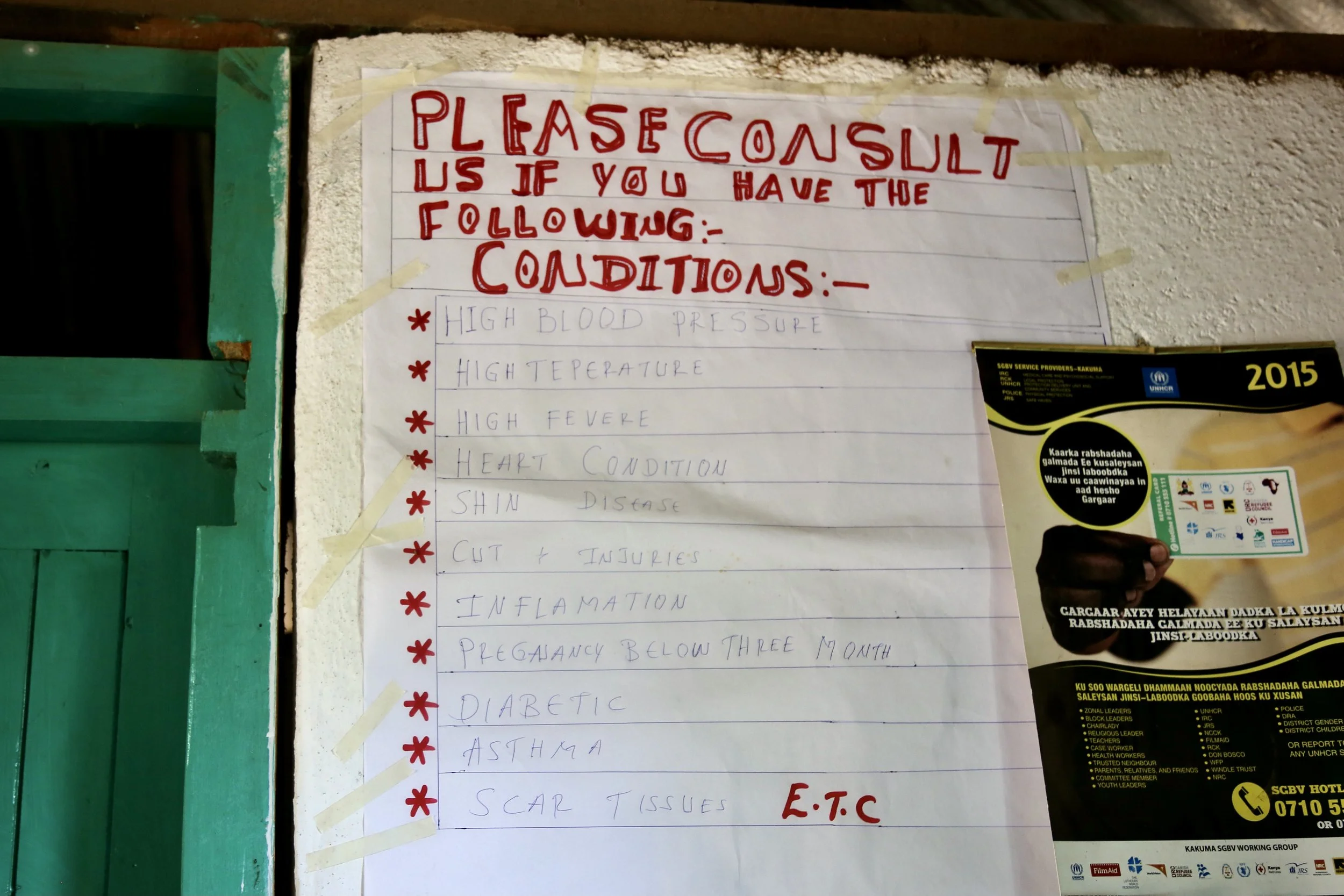 Rules and notices hang inside the entrance of the shelter, where daily life was structured around safety, confidentiality and shared responsibilities.