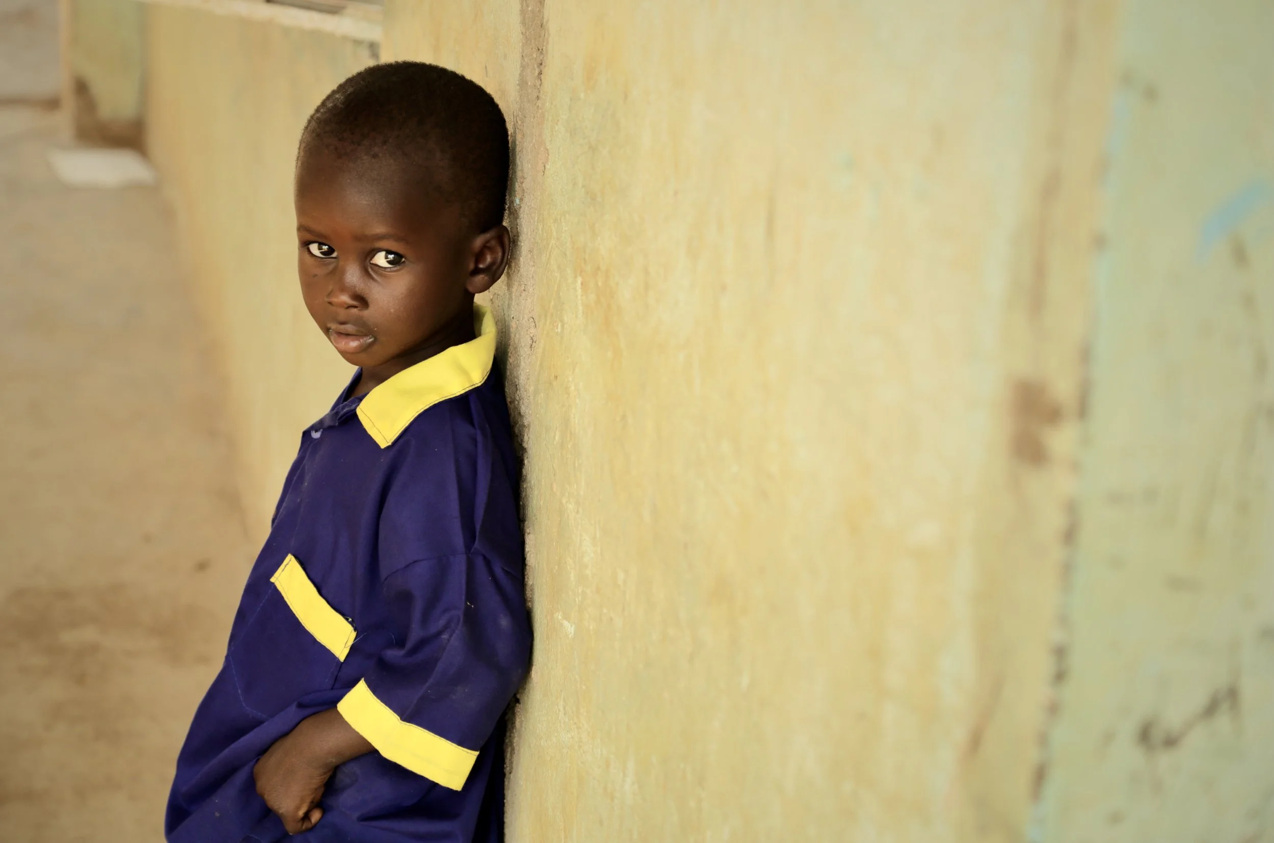 A pupil stands outside a classroom at Shinyunzu Primary School in Kakamega County, Kenya. Safe