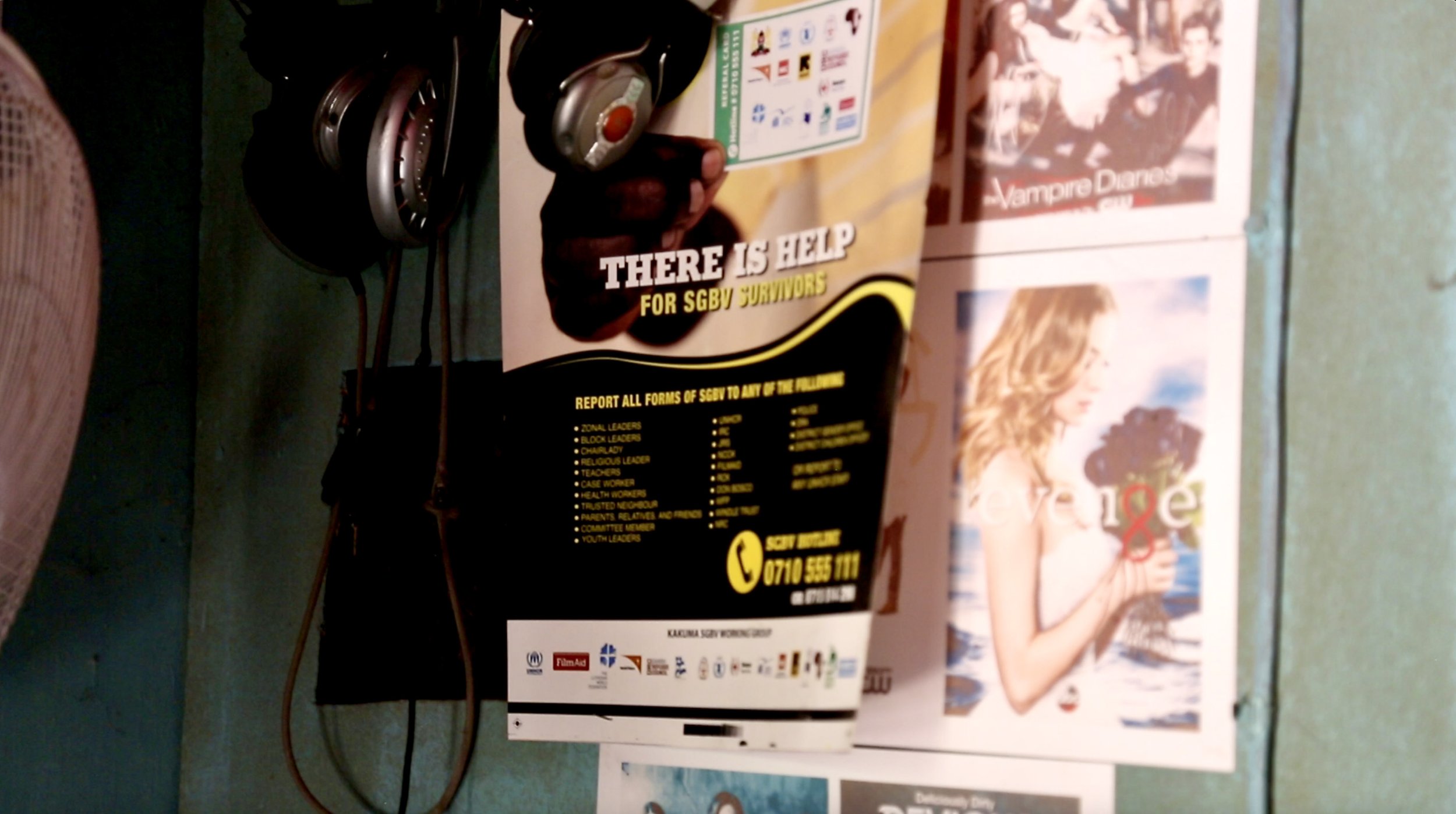 A poster addressing support for survivors of gender-based violence hangs inside the studio, showing how media spaces in the camp also served wider social and community needs.