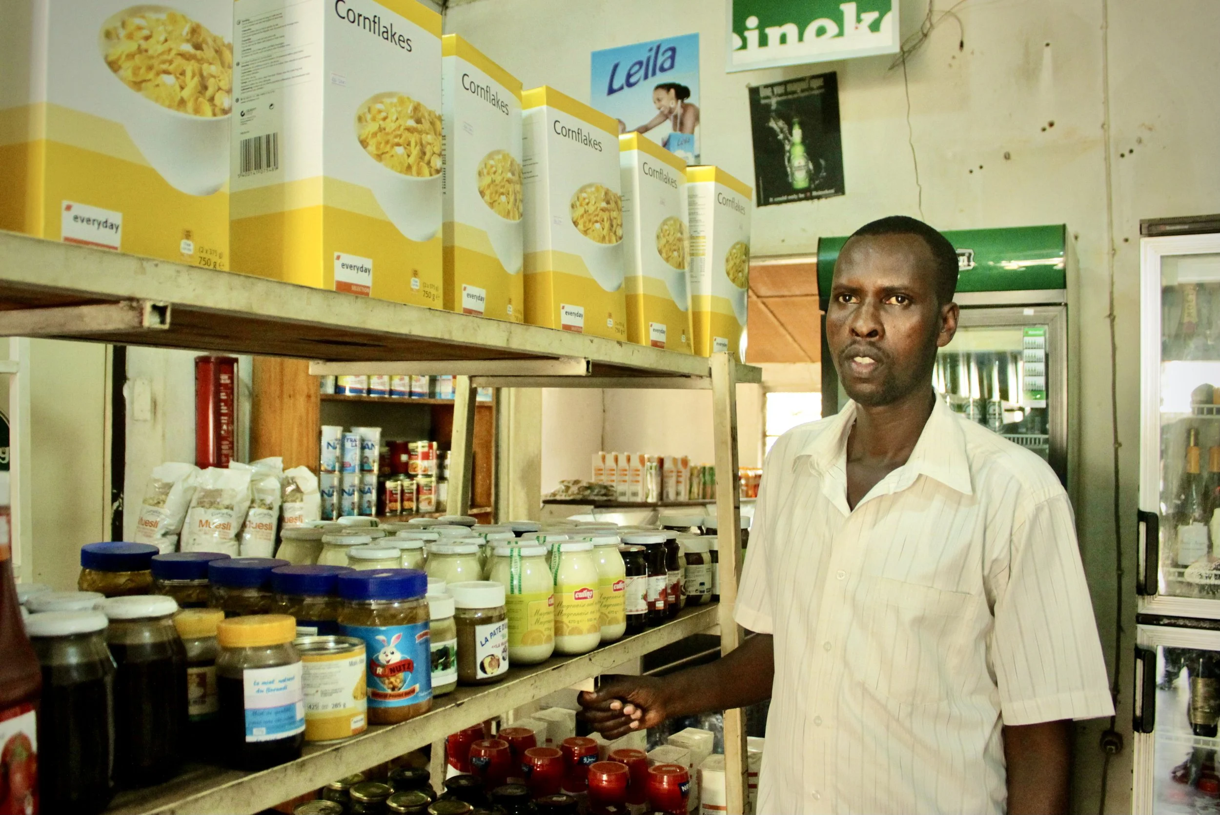 Diomede, 35, stands inside the Fido Dido grocery store. "For now, there is no plan to change the way we work here, but we will have to endure whatever happens," he said.