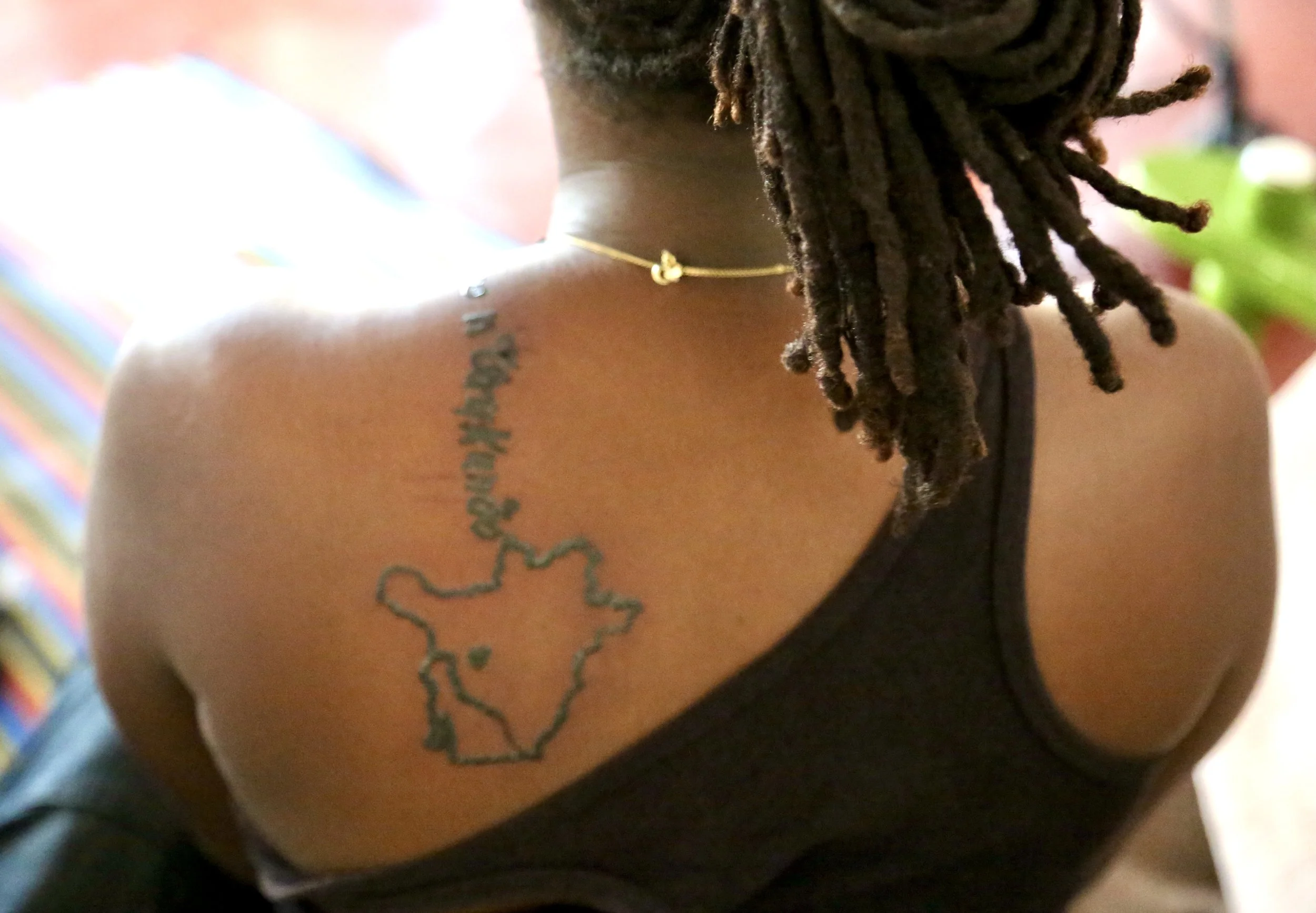 A tattoo referencing Burundi is seen on the back of Burundian activist Pamela Kazekare in Kigali, Rwanda. For many young Burundian refugees living in exile after the country’s 2015 political crisis, tattoos became expressions of identity, memory and 