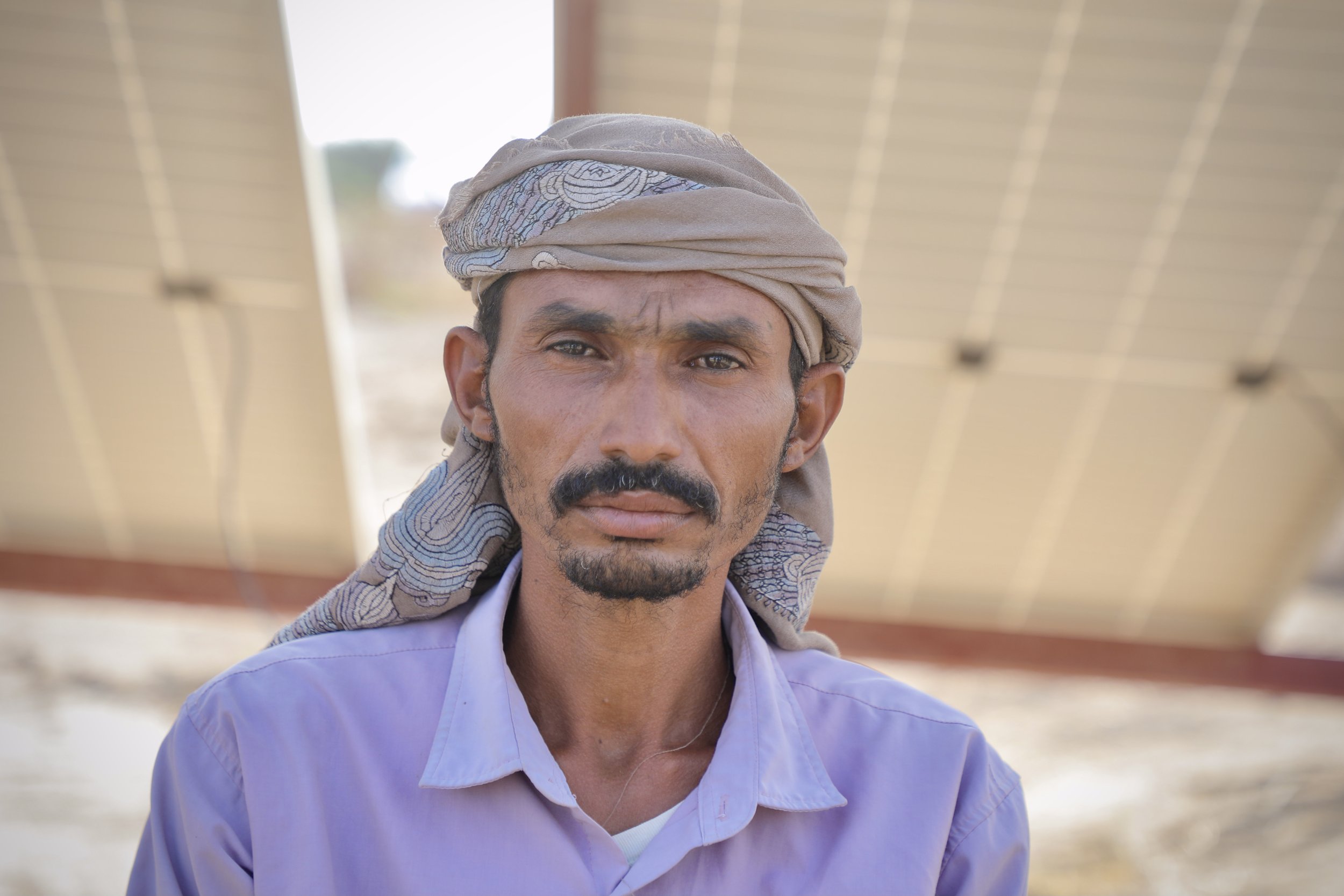 Portrait of Amar Mohamed Abdu, a father of five who returned to his farmland after displacement to find it contaminated with mines and unexploded ordnance. Clearance has allowed him to resume planting on part of his land.
