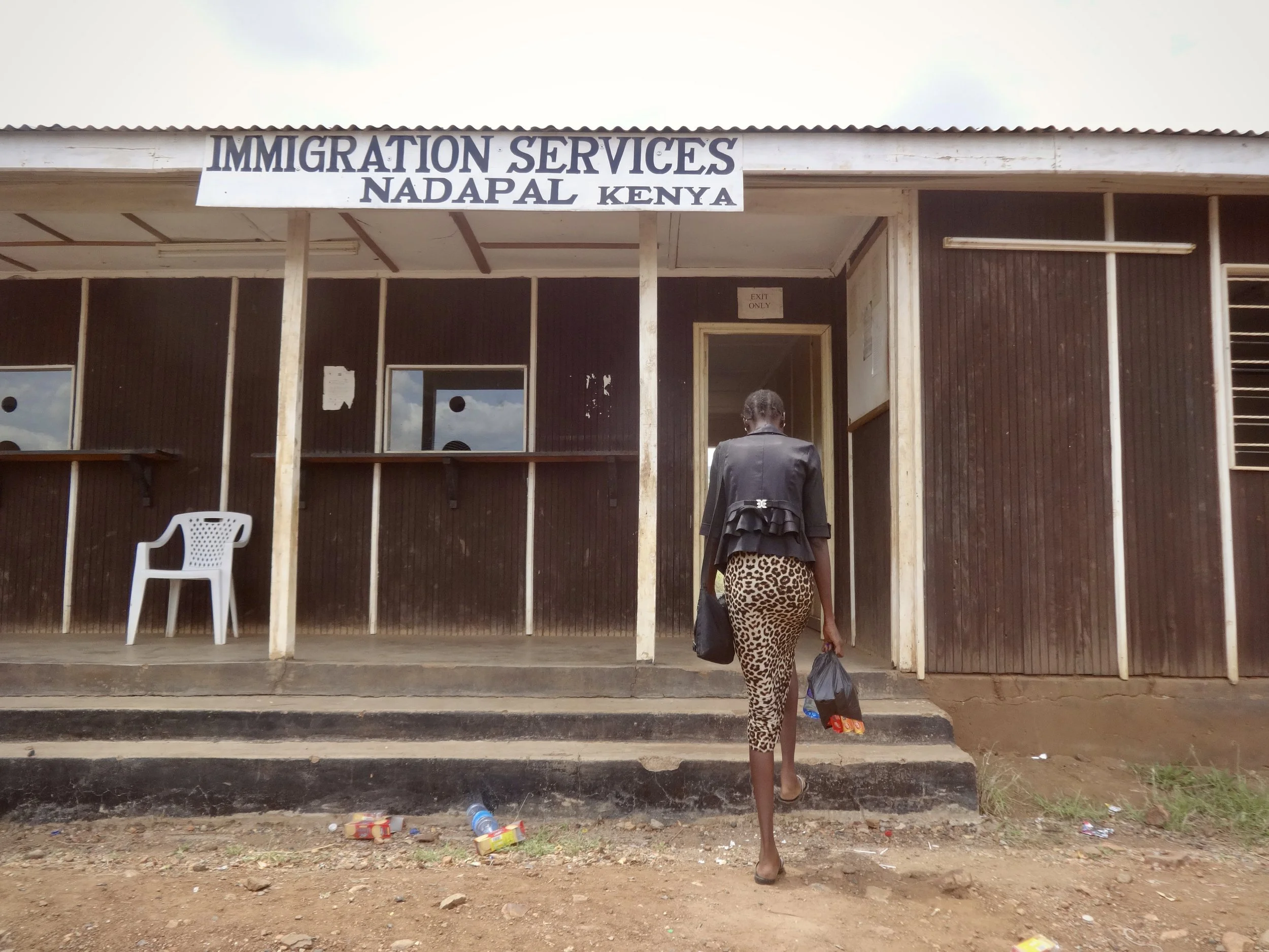 Randa approaches the Immigration Services office on the Kenyan side of the Nadapal border after intervention from officials who pressed for her case to be reconsidered, allowing her to proceed with her asylum claim.