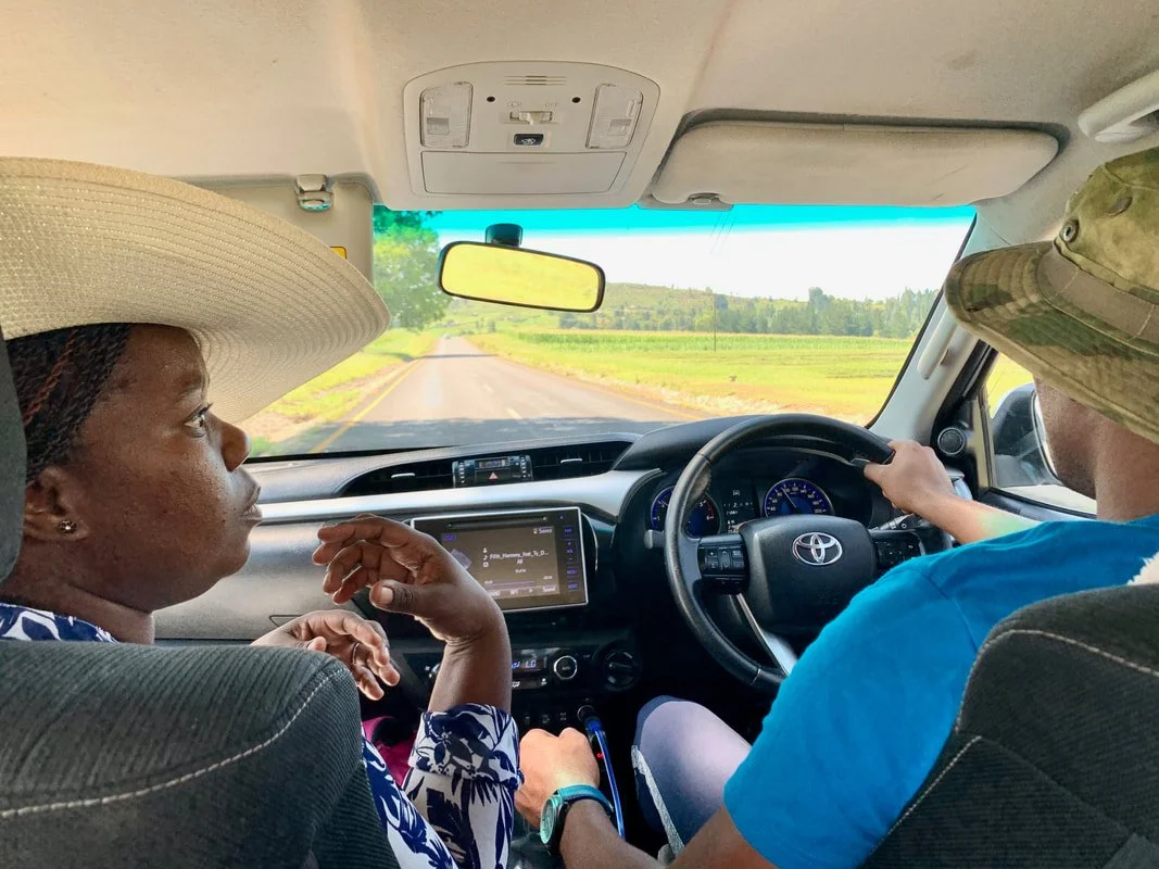 Programme coordinator Lulu (left) and a driver ask for directions while searching for herd boys who will attend an HIV and sexually transmitted infection (STI) prevention session in Leribe district, Lesotho. Outreach teams often travel long distances