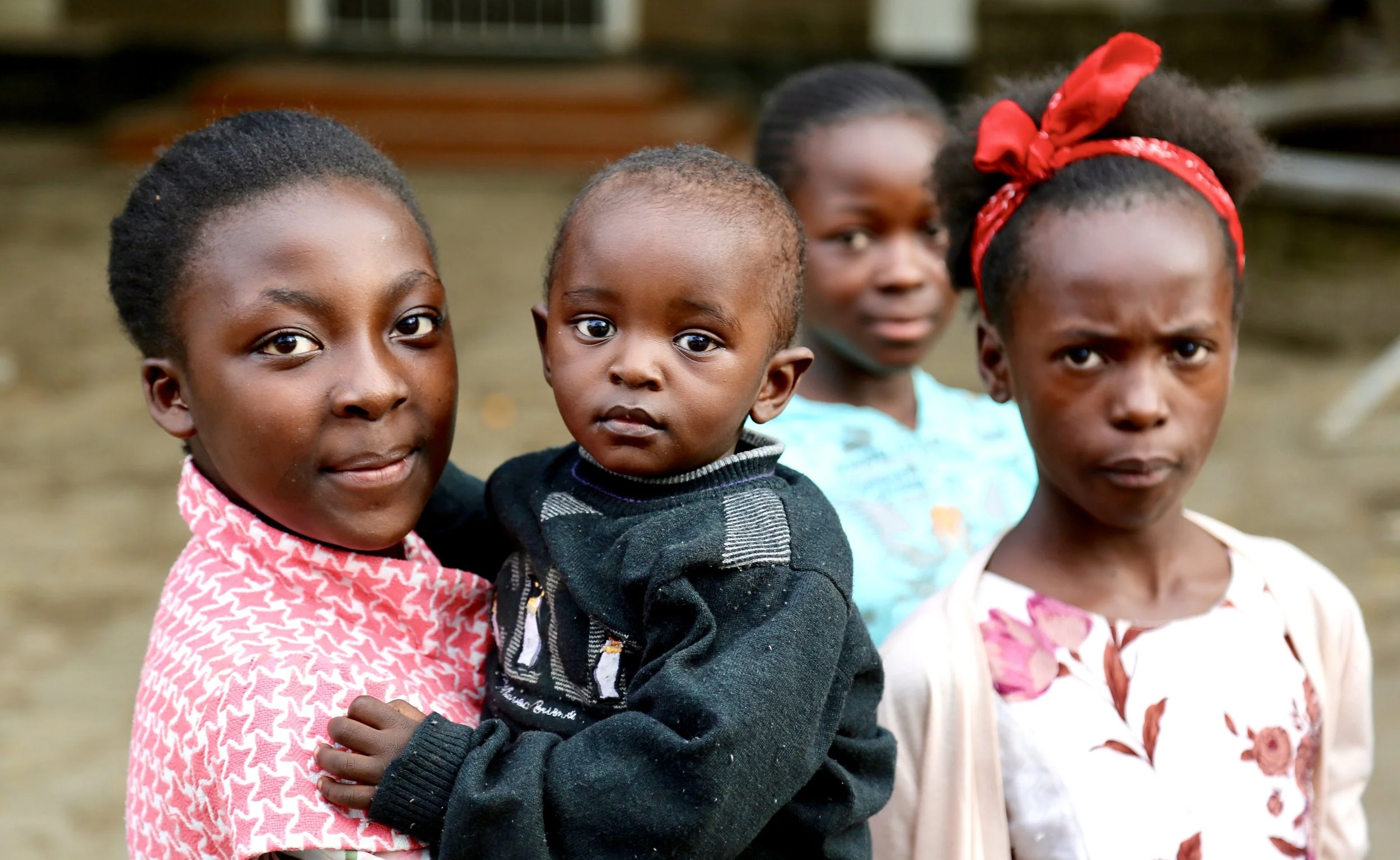 Children gather near a basketball court during World Refugee Day celebrations at Divine Word Church in Kayole, Nairobi.