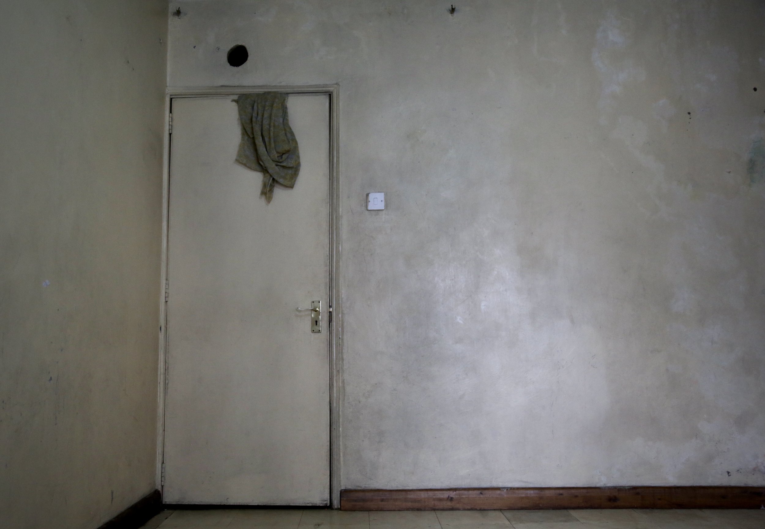 An almost empty room inside an apartment occupied by Somali refugee women in Eastleigh, Nairobi. The sisters spent much of their time confined indoors, fearful of being stopped by police if they left the building. Nairobi, Kenya, June 2016.