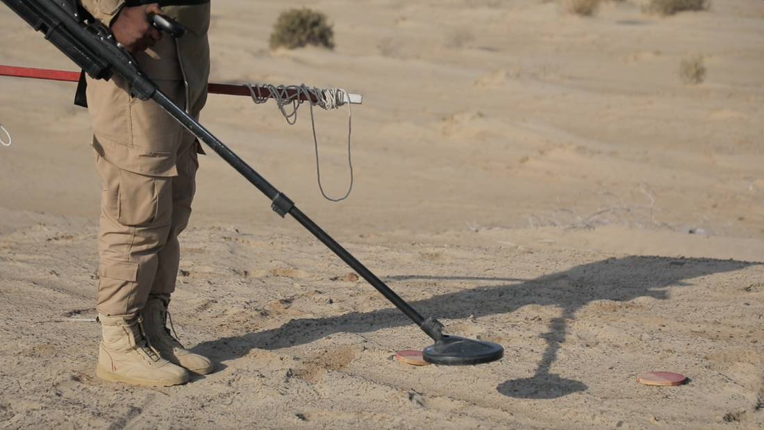 A mine detector sweeps across contaminated ground near the western Yemeni coastline.