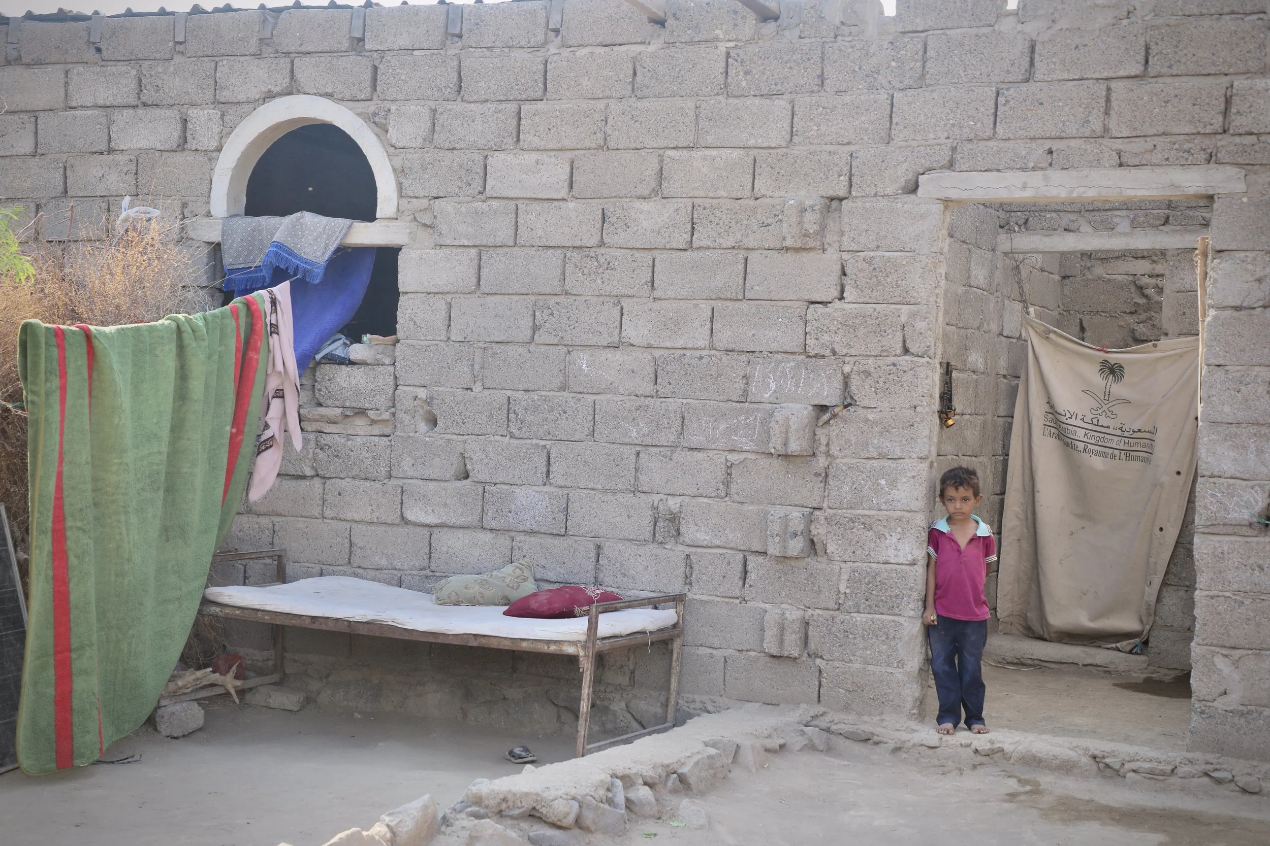 Amar's house in Al Remah, patched with tin sheeting, bears the marks of years of conflict. Families returned only after deminers confirmed their homes were safe.