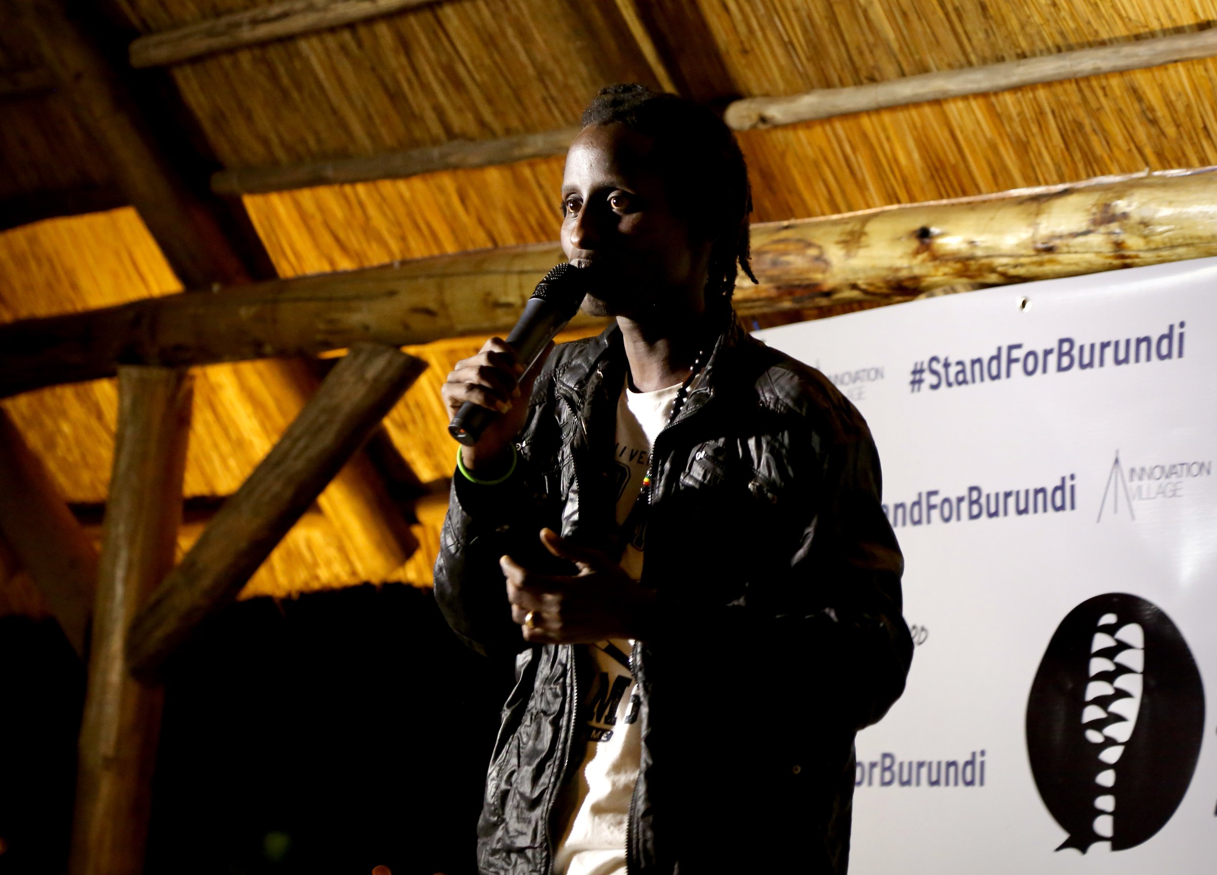 Bertrand Ninteretse, a Burundian refugee artist who performs under the name Kaya Free, sings during the #StandForBurundi spoken word and music event in Kigali, Rwanda. Written especially for the evening, his song reflected on displacement, separation