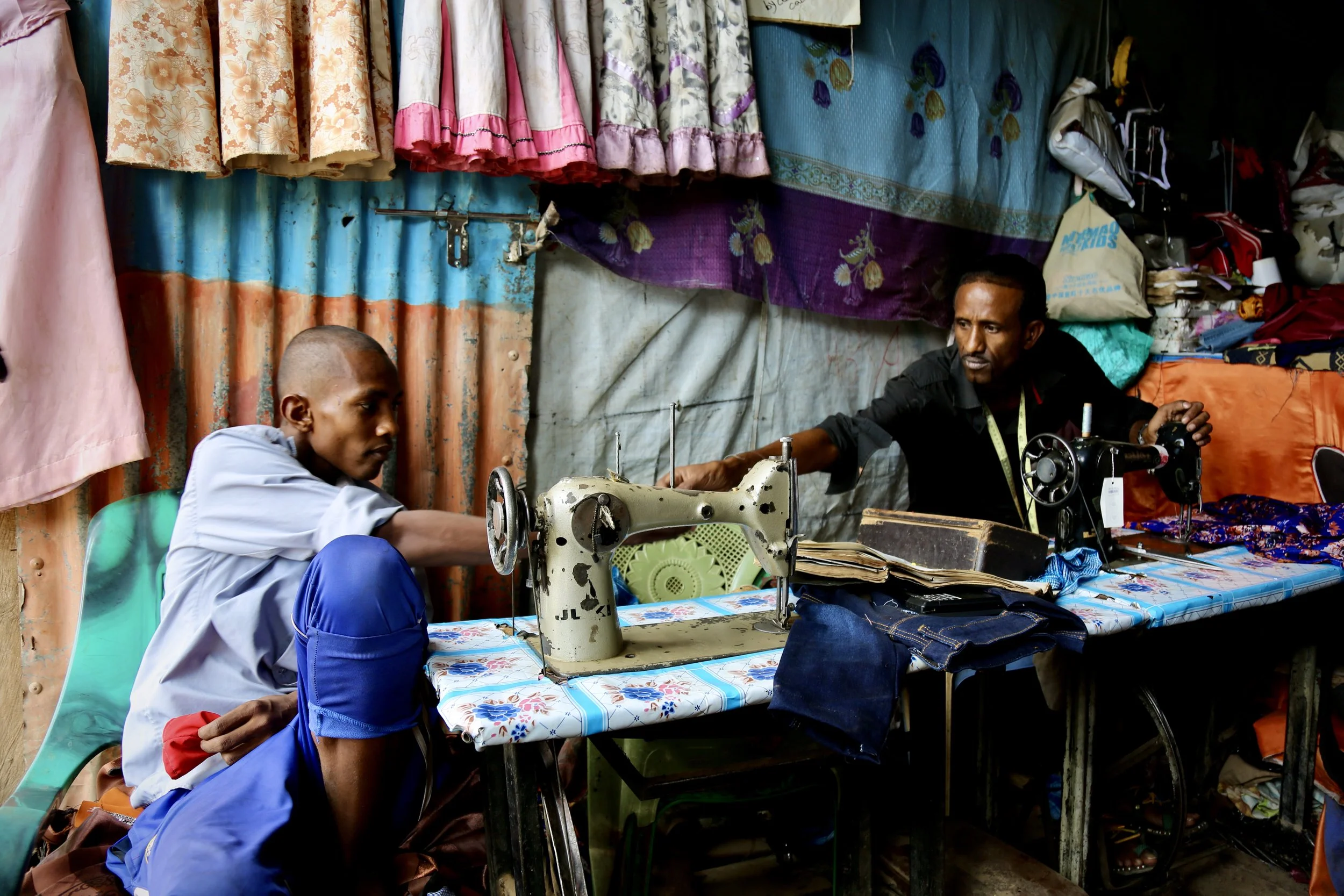 Work and conversation take place side by side inside the shop.