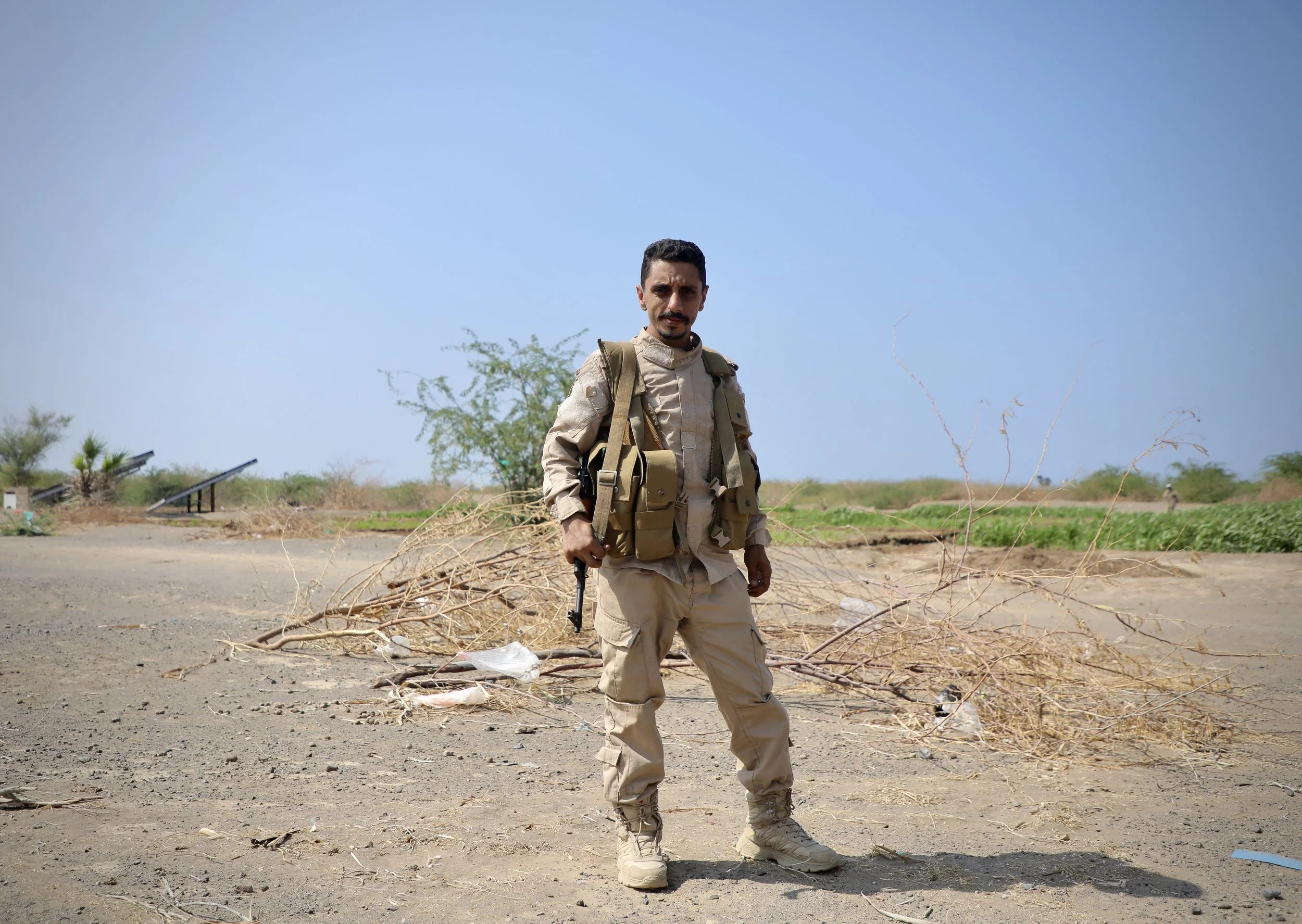 A security guard stands near a demining site in Al Remah, near Mocha, Taiz governorate, Yemen.