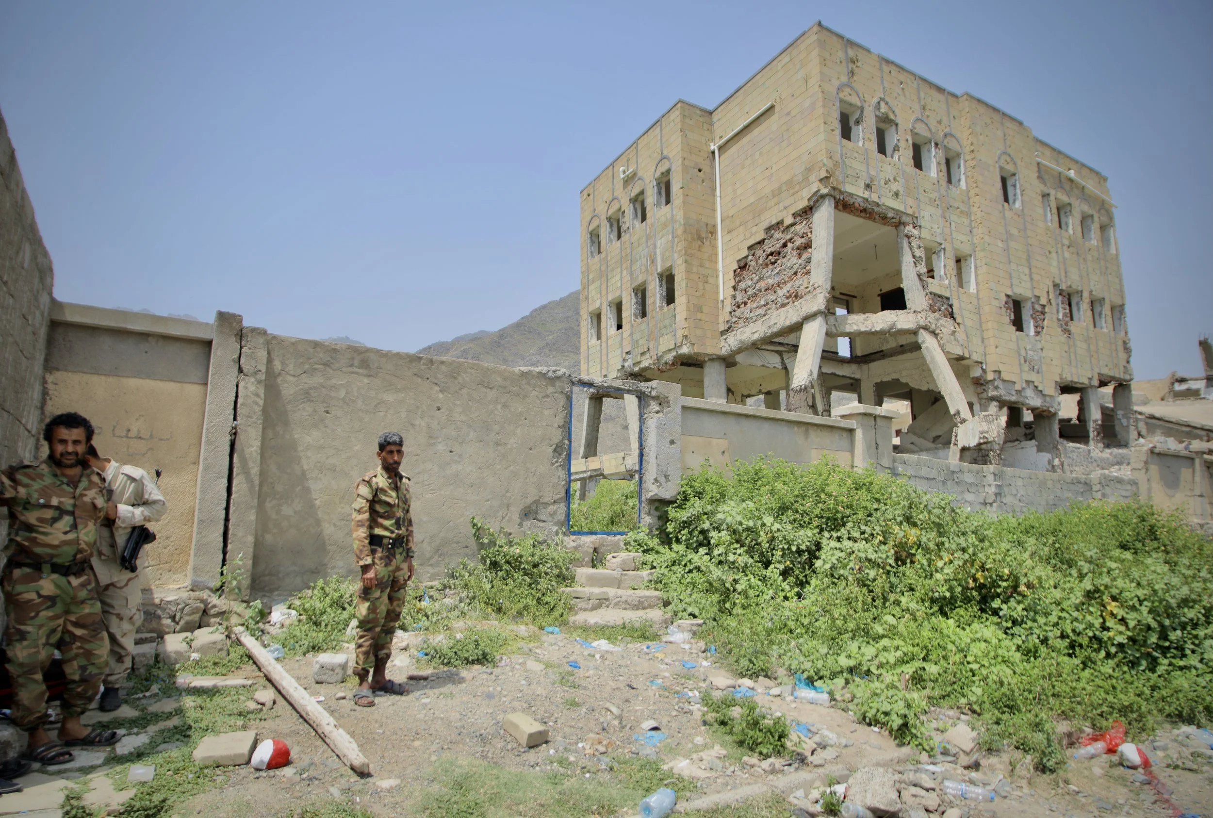 A damaged building stands near a former battleground in western Taiz, Yemen. Clearance teams prioritise roads, schools, homes and public areas affected by explosive contamination to allow displaced families and residents to return safely.