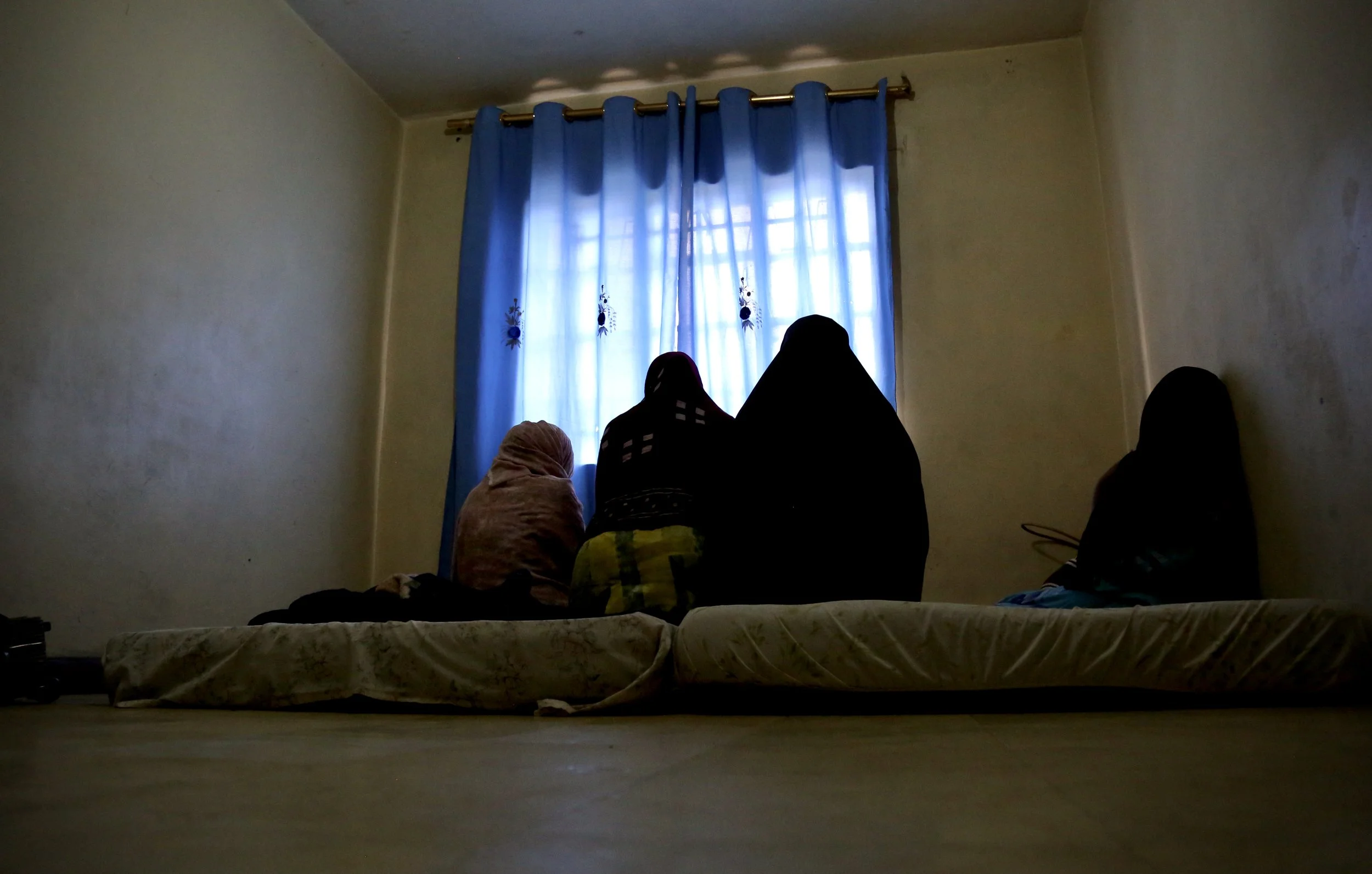 Four Somali refugee sisters sit together inside their shared room in Eastleigh, Nairobi. Their father sent them from Kakuma refugee camp to the capital after reports of attacks against women and girls in the camp. Nairobi, Kenya, June 2016.