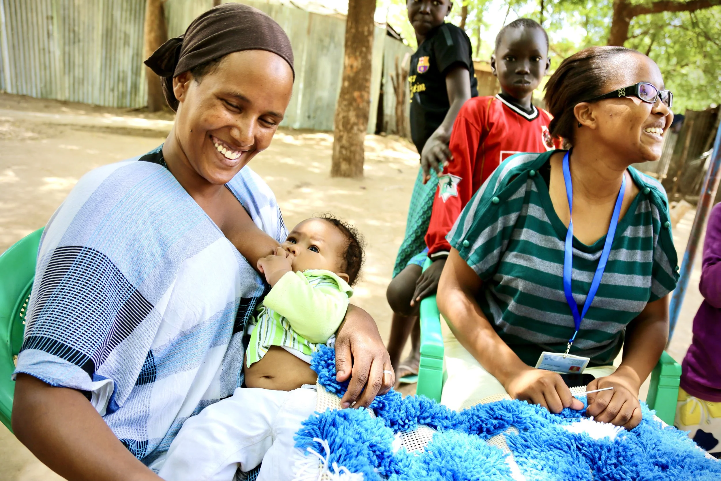 Residents work together on fabric in the shelter courtyard. Practical skills and communal labour helped many women regain confidence after trauma and displacement.