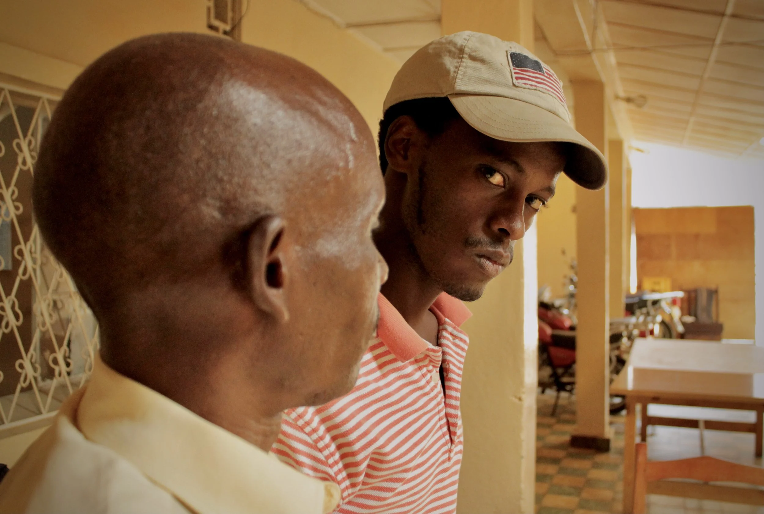 Psychologist Christophe Nibasumba listens as torture survivor P. Sinzinkayo recounts his detention and alleged abuse at APRODH's offices in Bujumbura, Burundi, July 2015. Nibasumba, who treated him following his release, said the torture had left las