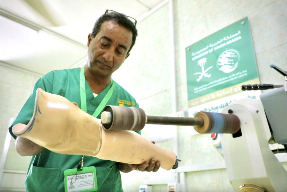 A technician sands and shapes a prosthetic socket during the fabrication process at the Artificial Limbs Centre in Aden. Once measurements are completed, staff require between five and nine working days to produce a tailor-made artificial limb.
