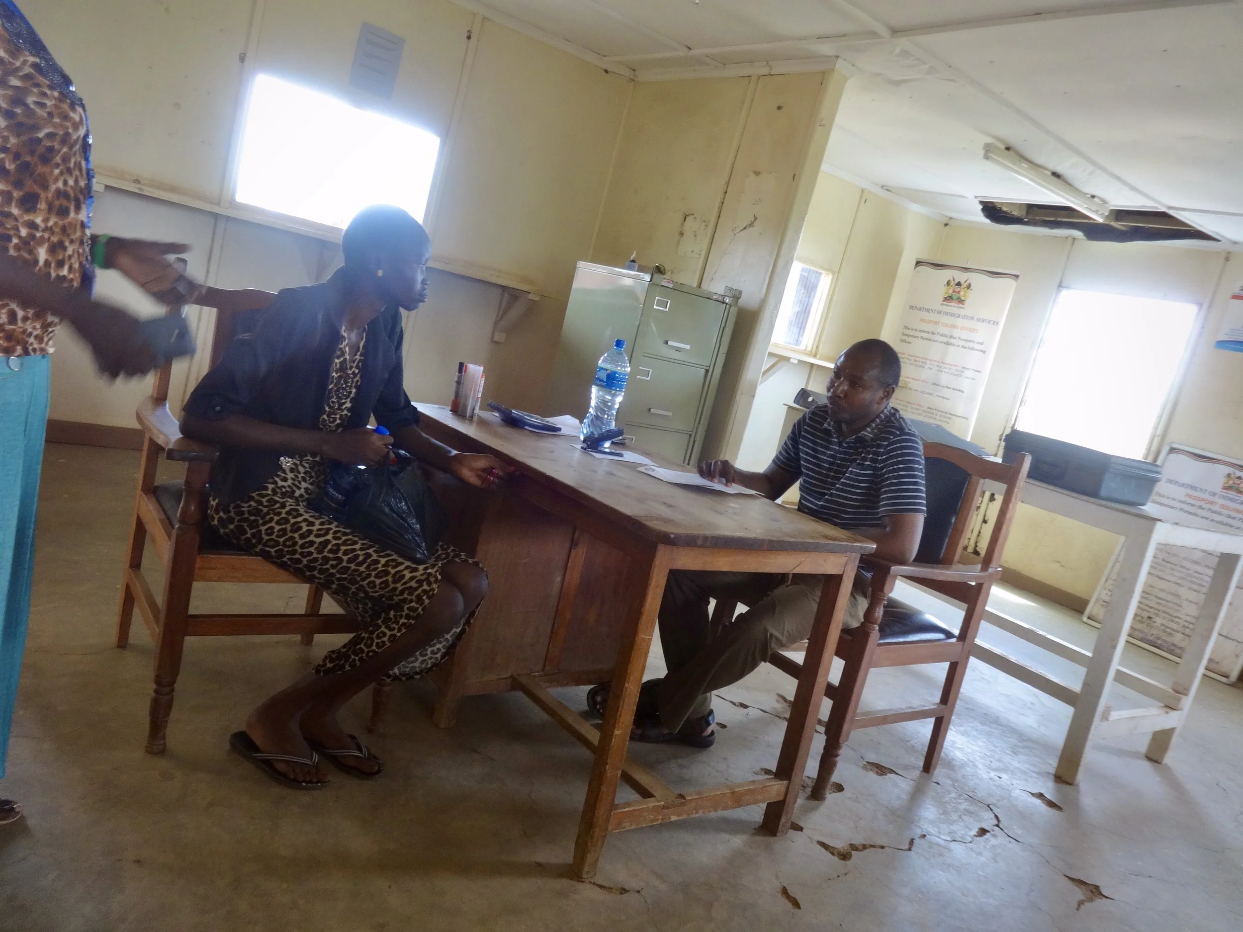 Randa is interviewed inside the Immigration Services office on the Kenyan side of the Nadapal border as officials review her case before allowing her to proceed with her asylum claim.