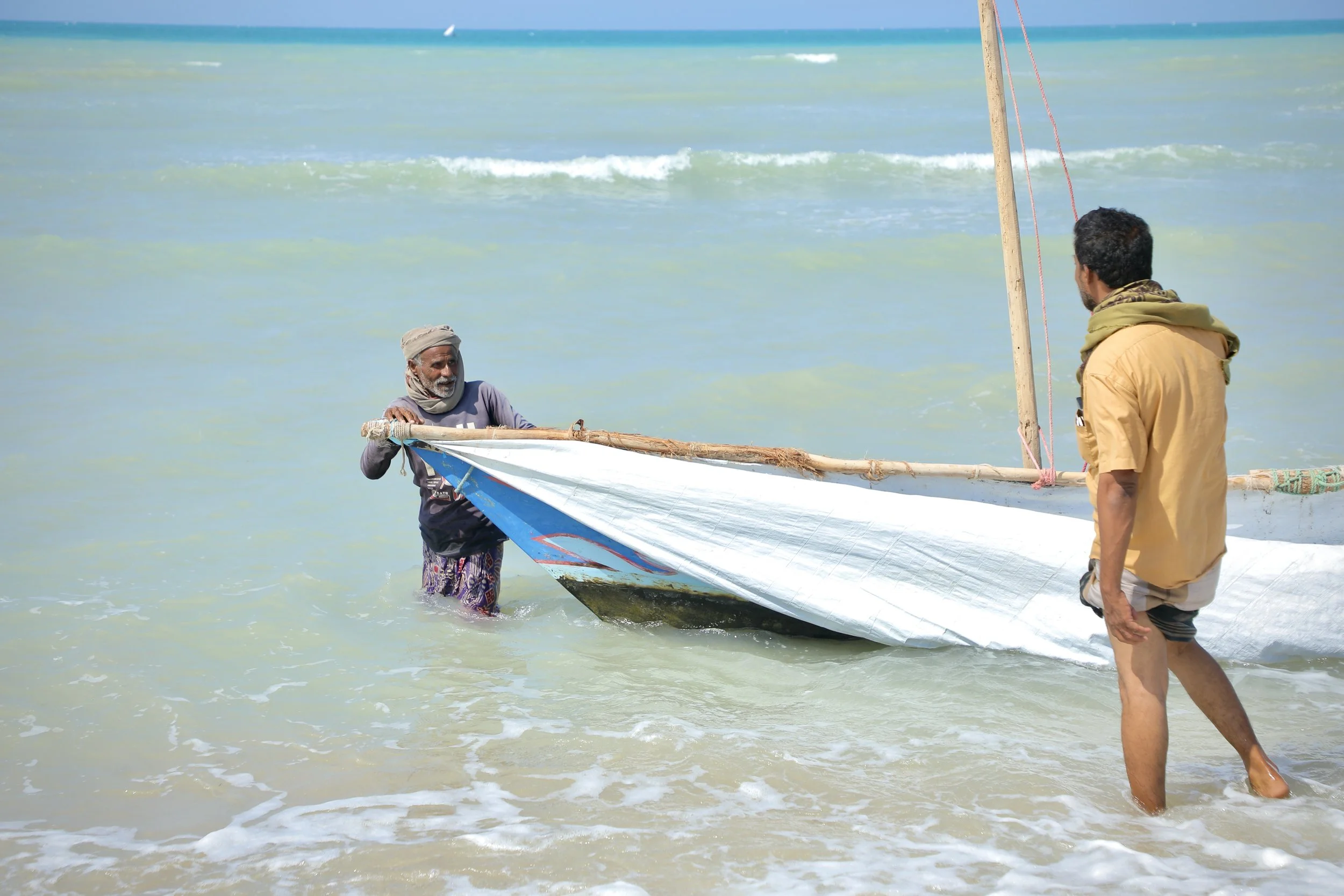 Fishermen bring a wooden boat ashore in Al Khokha. Many now remain close to the coastline because of fears over naval mines and water-borne explosive devices in deeper waters.