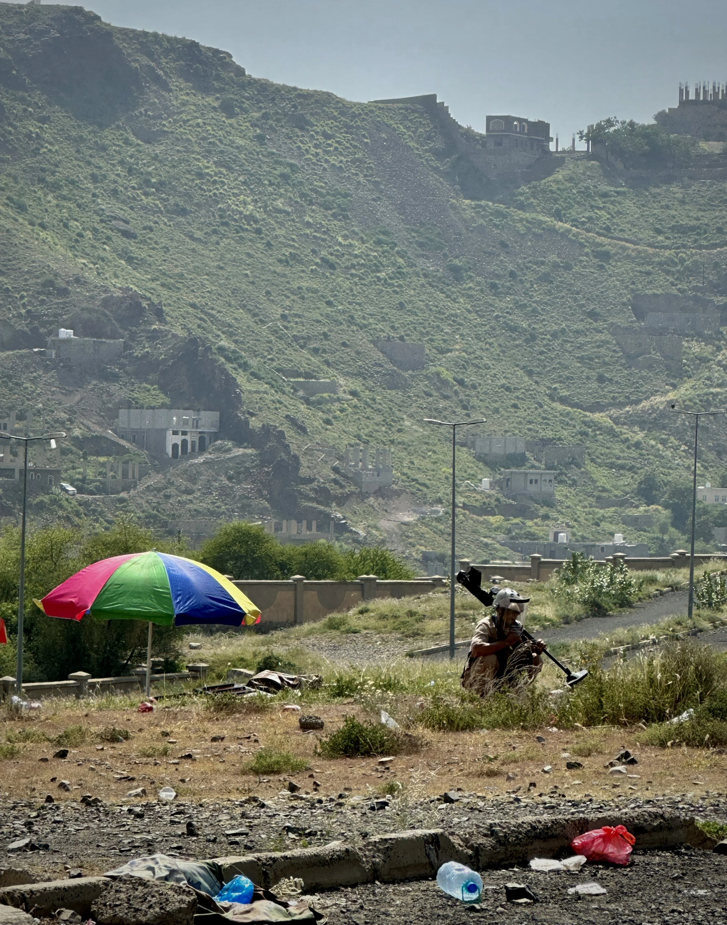 A deminer clears contaminated terrain during operations in Taiz, Yemen - behind the location of the EORE session. Humanitarian clearance teams continue to work across mountainous and rural areas affected by landmines, improvised explosive devices and