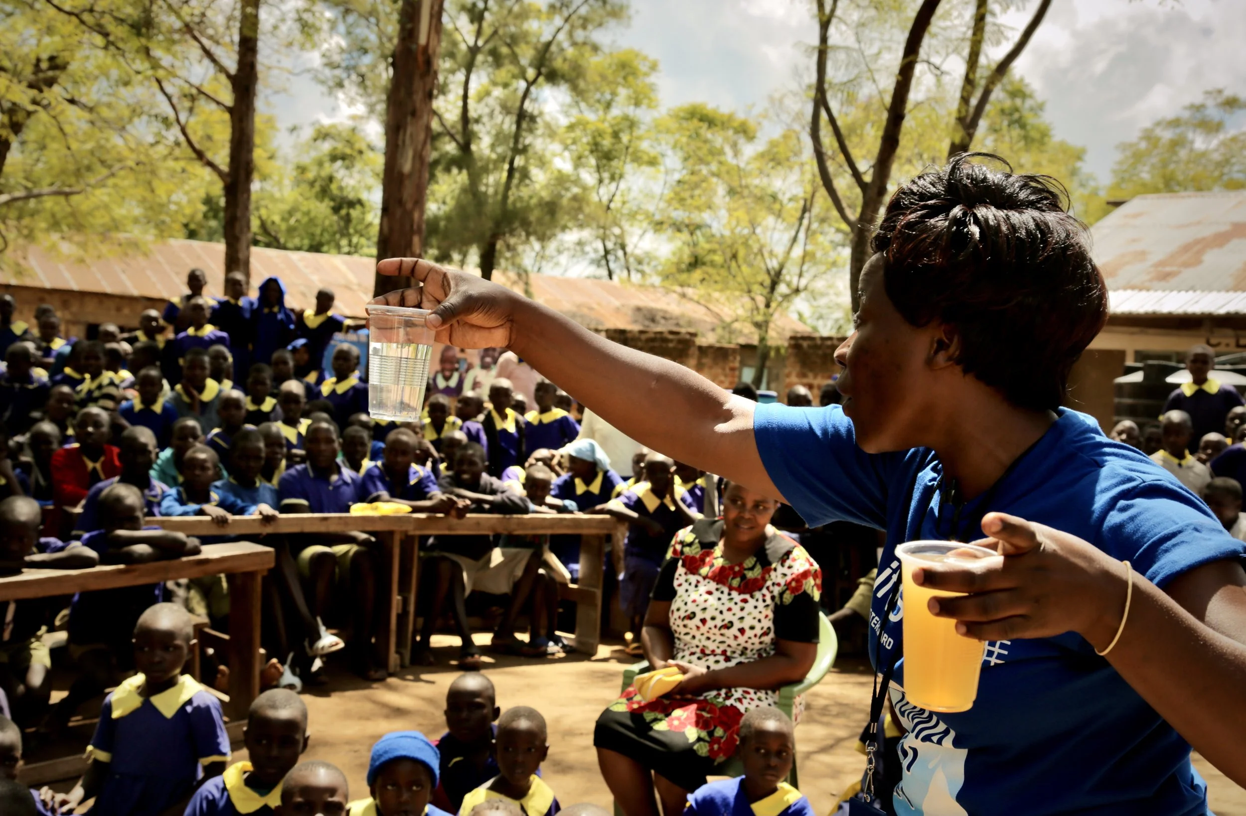 A health educator working with LifeStraw Community speaks to pupils during a water, sanitation and hygiene awareness session at Shinyunzu Primary School in Kakamega County, Kenya.