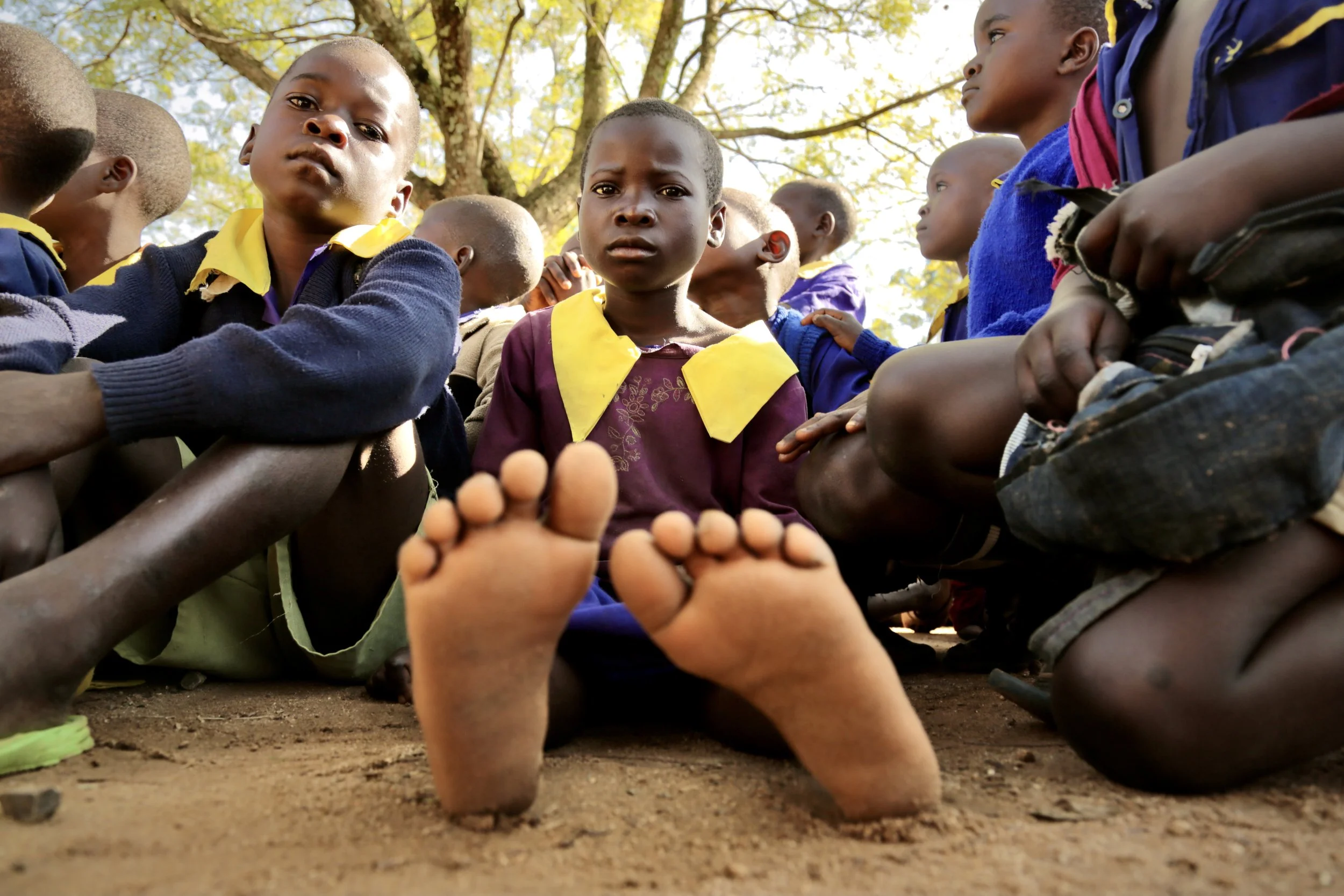 Pupils sit together during a school assembly at Shinyunzu Primary School in Kakamega County, Kenya. Access to safe drinking water is a daily concern for many schools in the region, where water shortages can affect hygiene, attendance and learning.