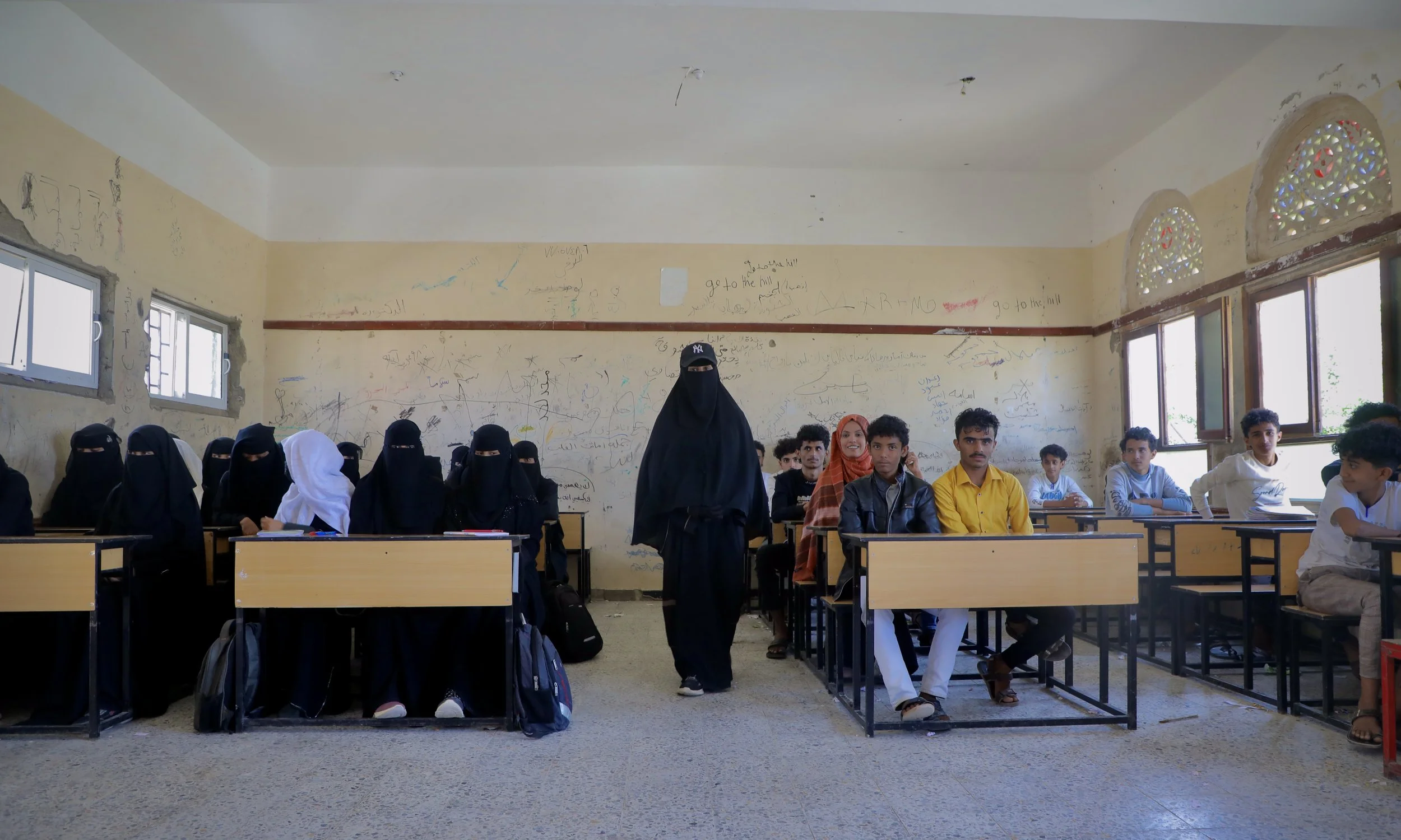 Students attend class inside Ibrahim Aqeel School in Taiz after the school partially reopened following damage caused by an explosion involving stored landmines and IEDs.