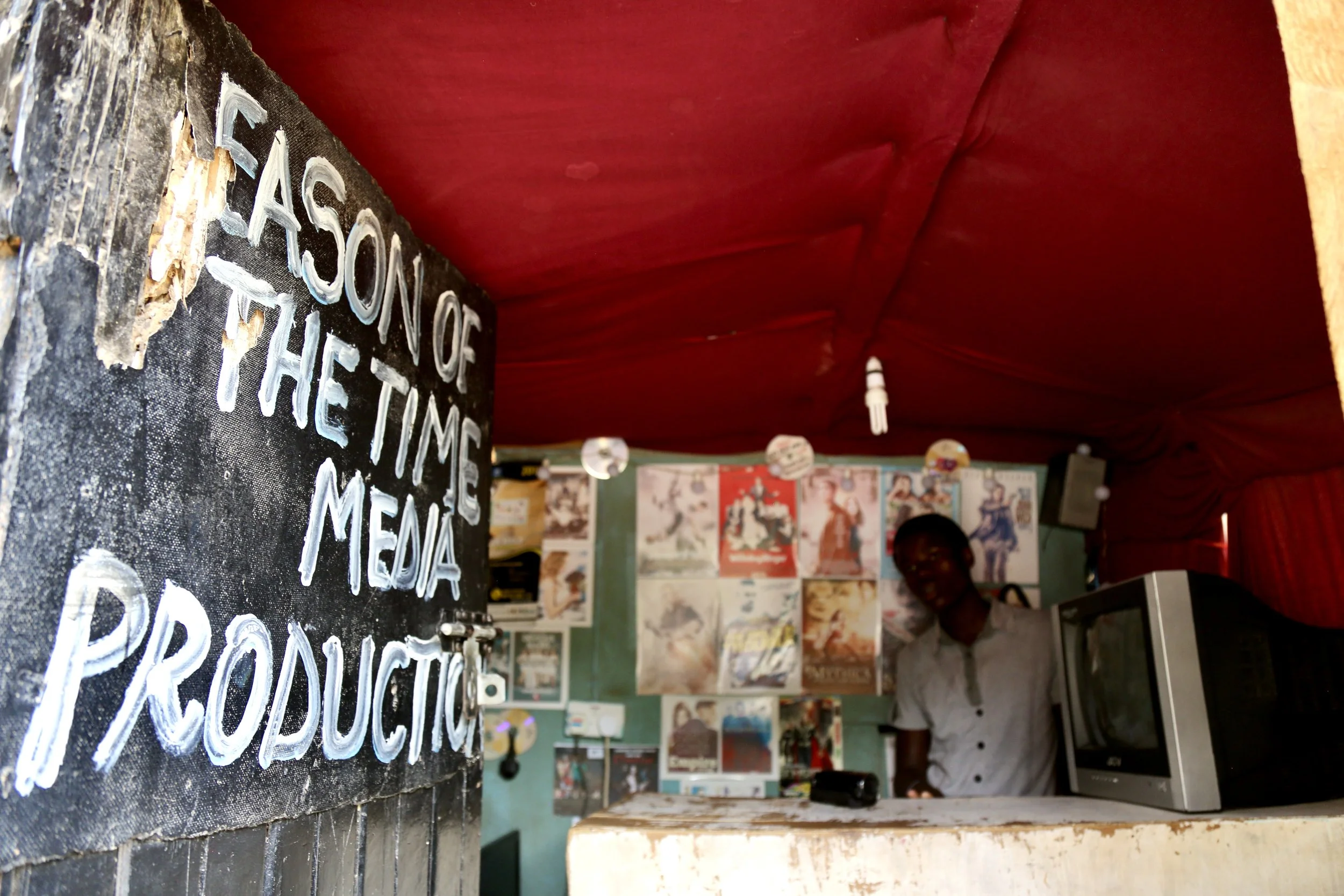The hand-painted sign inside Wabenga’s studio. The business provided photography, filming, and local storytelling services to camp residents.