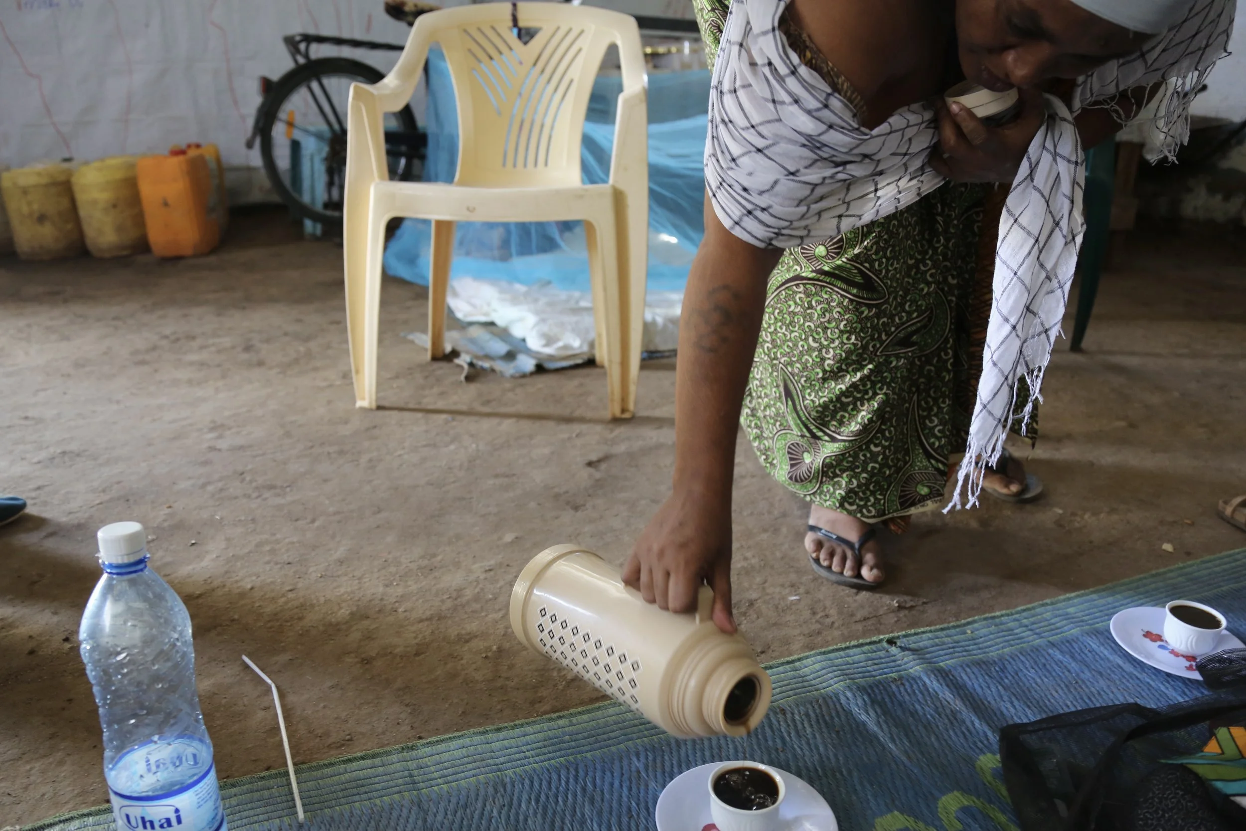 Nazrit’s mother serves coffee inside the family shelter. During the Ethiopia-Eritrea conflict, she faced deportation despite being married to an Ethiopian citizen.