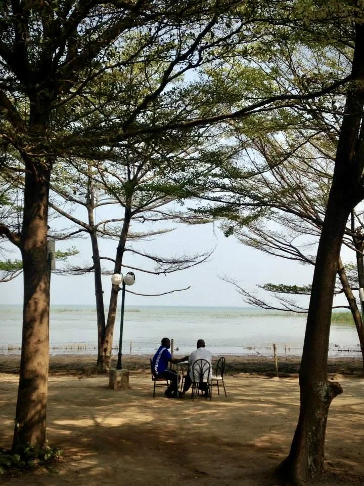 Two guests sit in the breakfast area of the Safari Gate Hotel overlooking Lake Tanganyika. Before Burundi's political crisis, the hotel regularly hosted tourists, diplomats and business travellers. By August 2015, staff said occupancy had fallen dram
