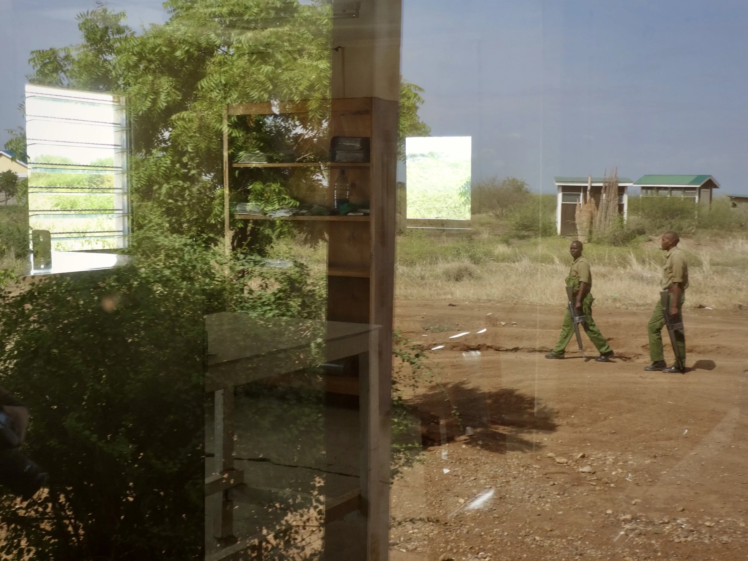 Through a window, Kenyan officials and security personnel move between the South Sudanese and Kenyan sides of the border, where access for asylum seekers had become restricted.