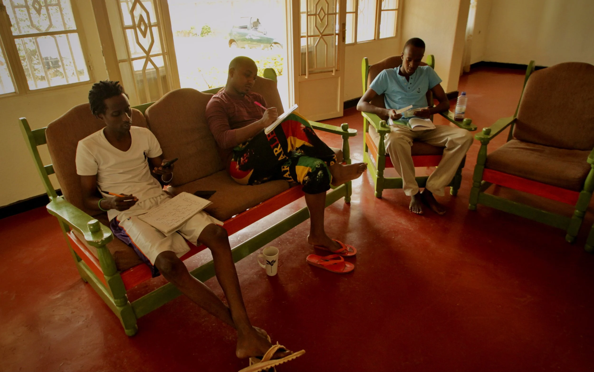 Residents read, study and discuss politics inside the Kigali compound where 14 Burundian refugees lived together in exile after fleeing Burundi’s 2015 political crisis. Unable to legally work in Rwanda, many spent long days inside the house waiting f