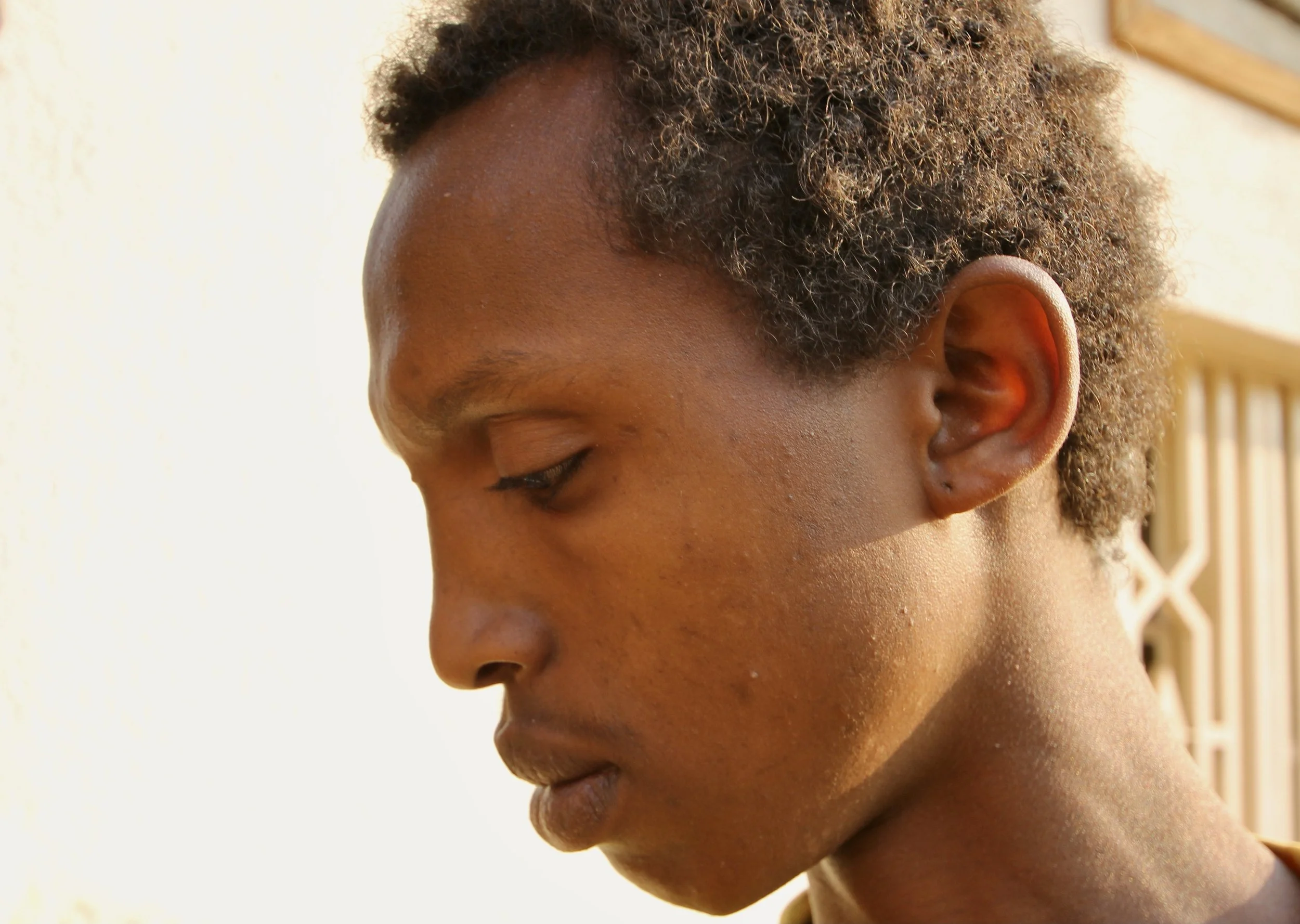 Justin Girukwigomba, a former student from Bujumbura, stands inside the Kigali compound where Burundian refugees, activists and former protesters lived together in exile after fleeing Burundi’s 2015 political crisis. After witnessing the killing of h