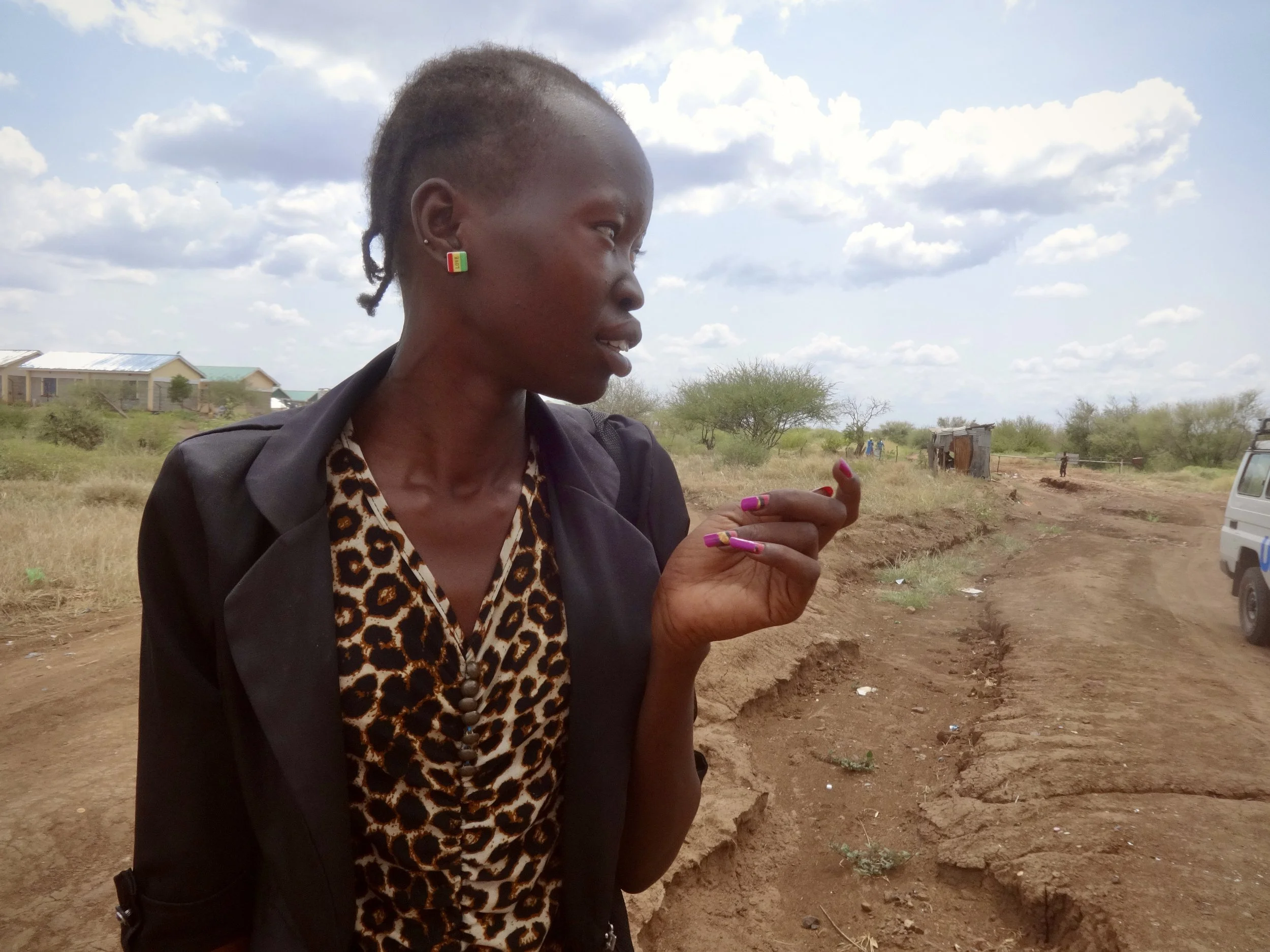 Randa pauses as she waits for news on whether she will be allowed to enter Kenya and continue her journey to Kakuma refugee camp.