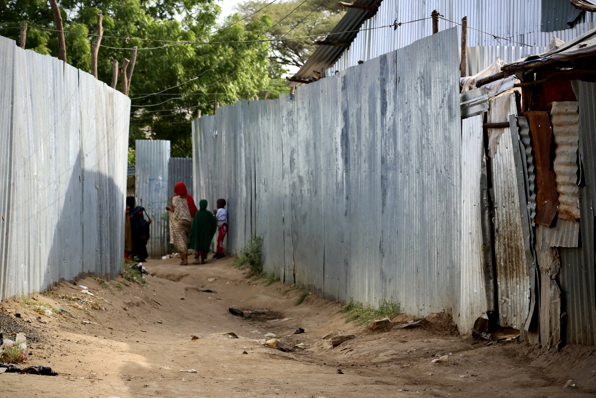 A narrow path runs beside the corrugated perimeter of the Safe Haven in Kakuma refugee camp, where women and children at risk were housed in a discreet protected shelter.